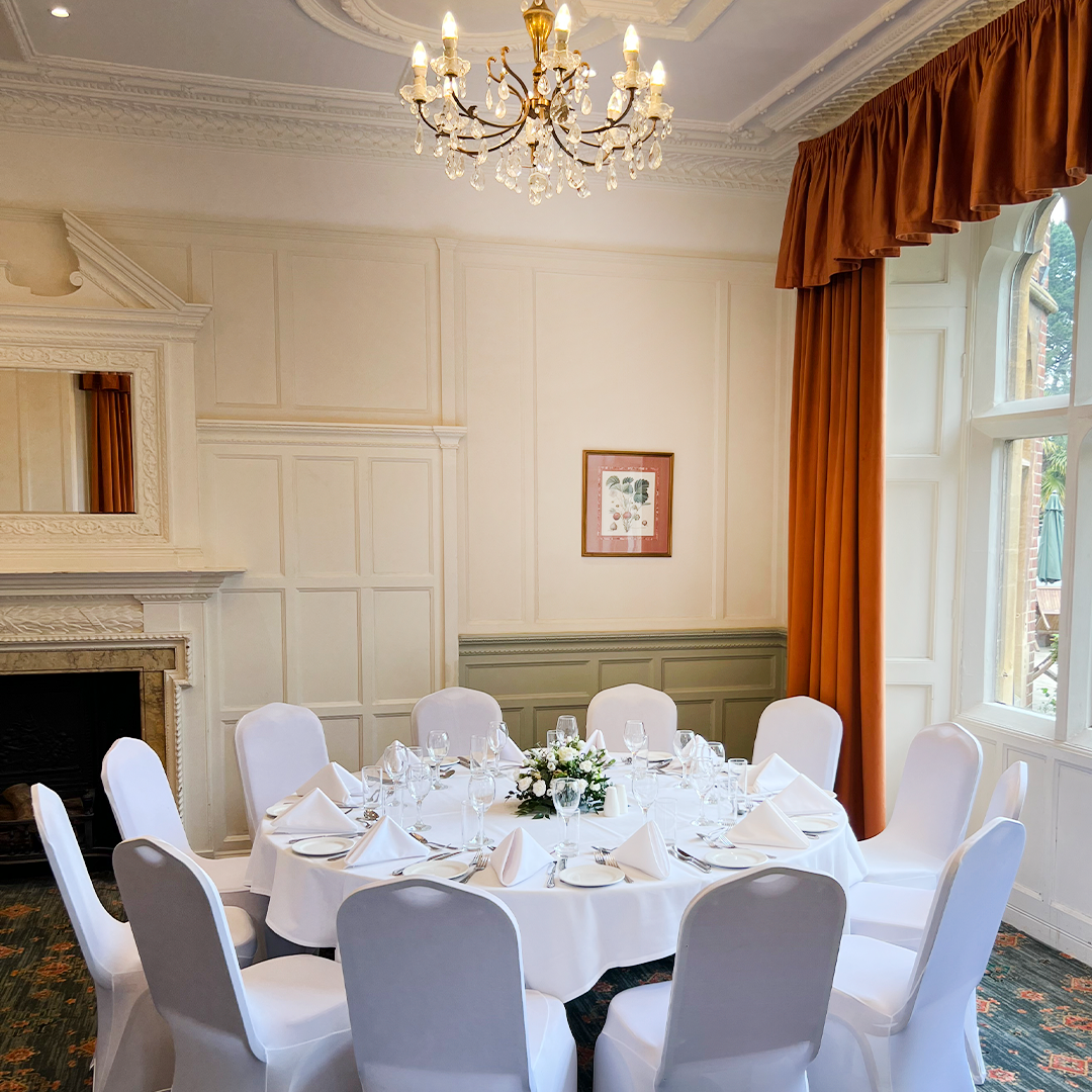 Elegant dining table with floral centerpiece at Warren House Hotel for events.