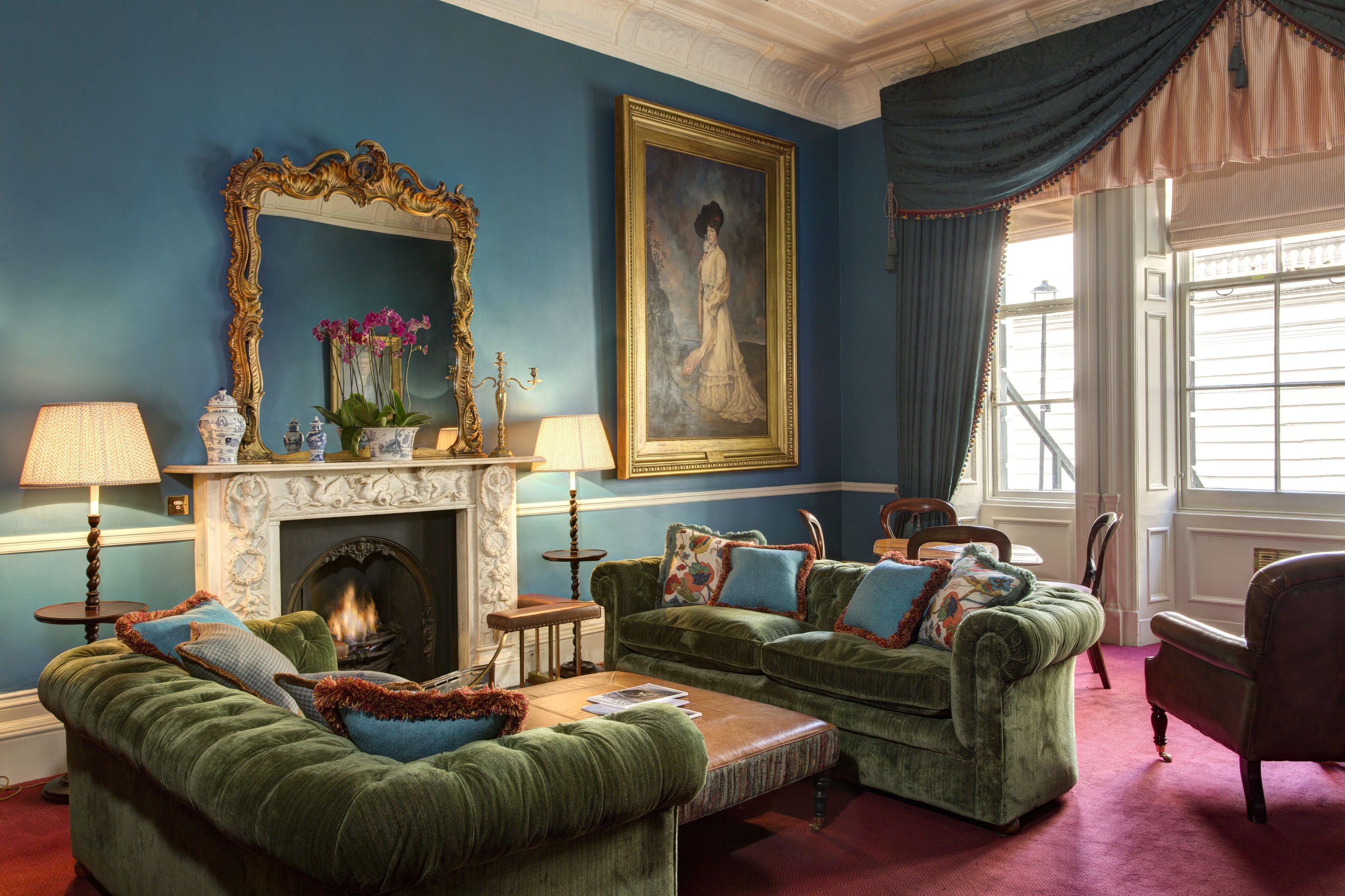 Elegant meeting space with plush green sofas at The Library at the Gore, ideal for networking.