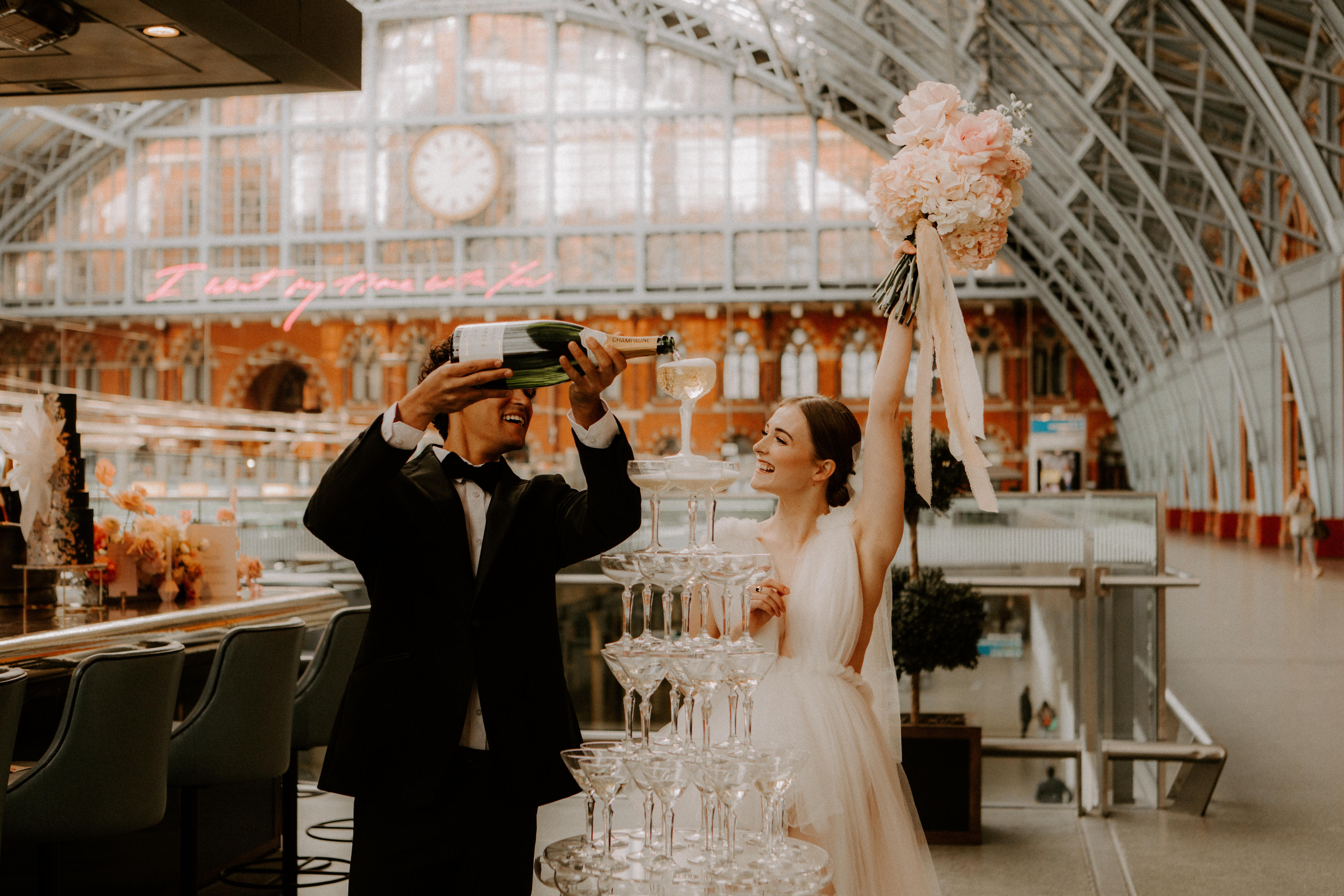 Elegant wedding at St Pancras Brasserie with champagne tower and stunning architecture.