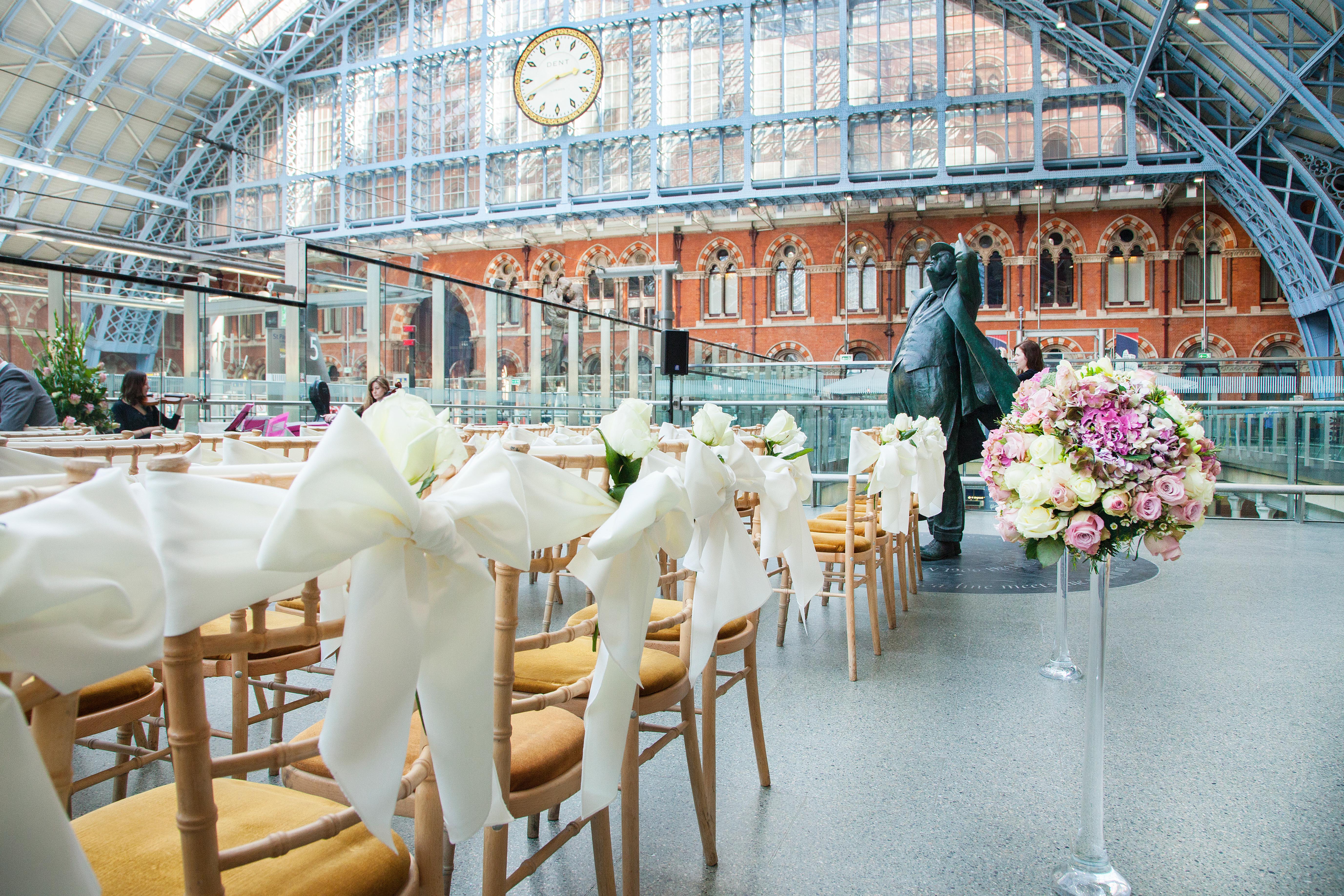 Weddings at St Pancras Brasserie with elegant chairs and floral arrangements.
