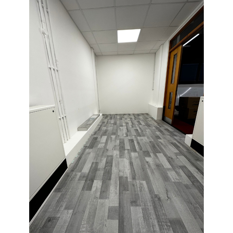 Minimalist Brave Gym space with gray flooring, ideal for events and meetings.