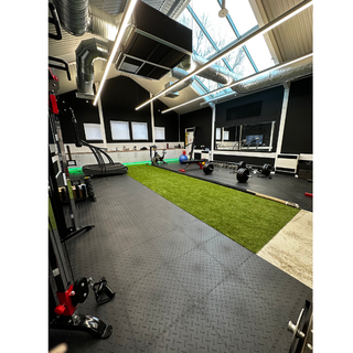 Versatile fitness space with turf flooring for corporate wellness events and team-building activities.