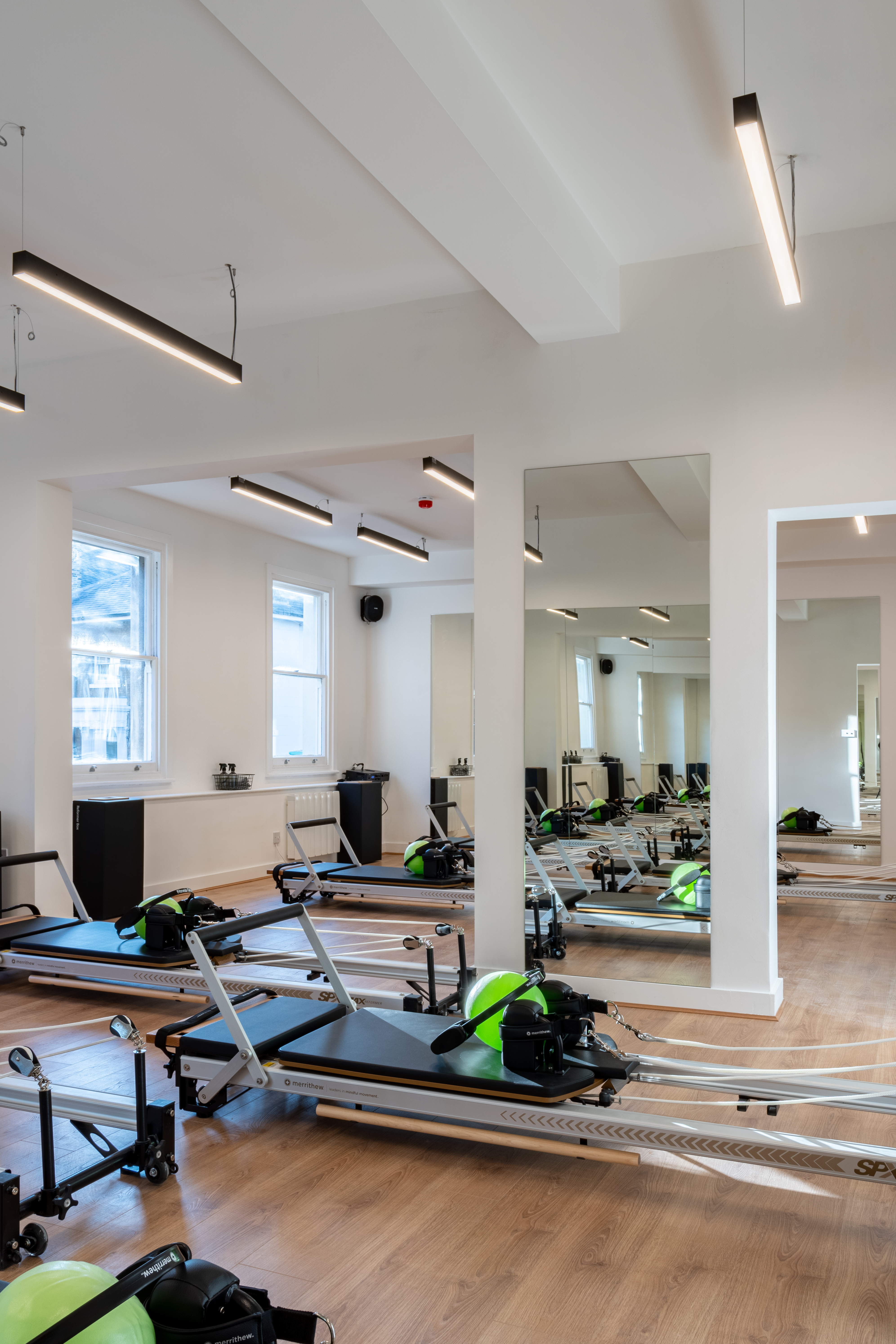 Modern fitness studio with reformer machines for wellness events in Brixton.