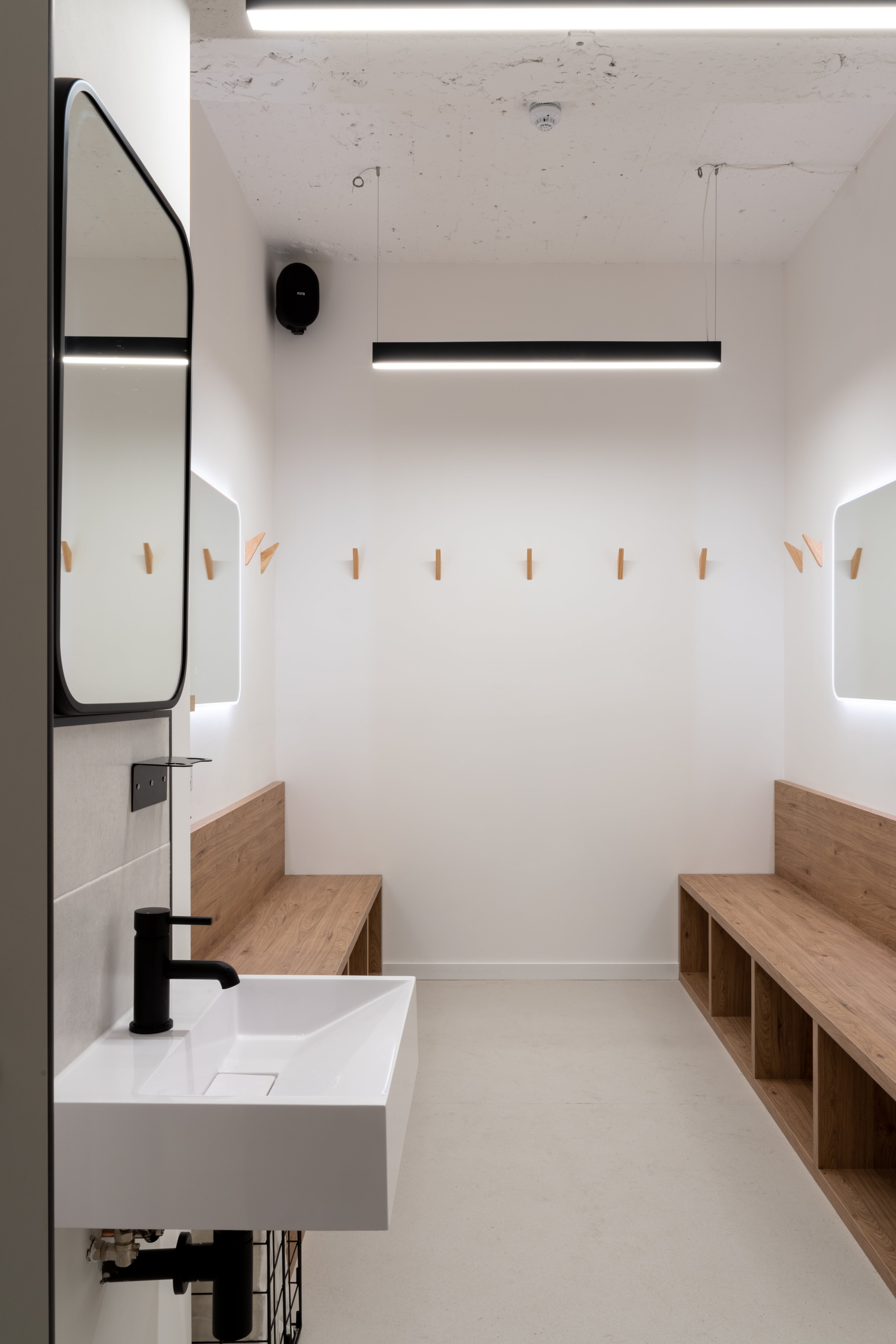 Minimalist changing room at LevelOut Brixton with dual mirrors for event preparation.