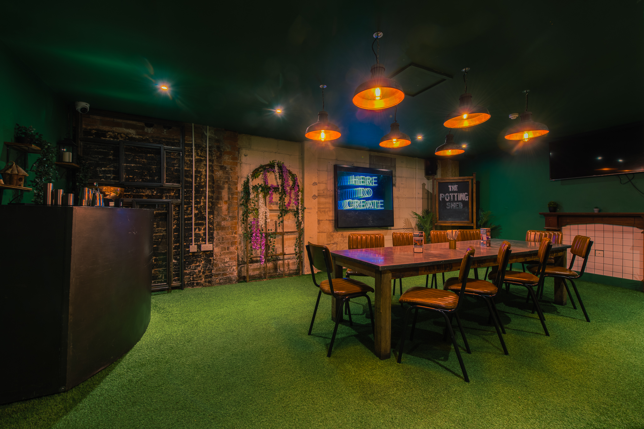 Stylish meeting room at The Potting Shed, featuring vibrant green carpet for workshops.