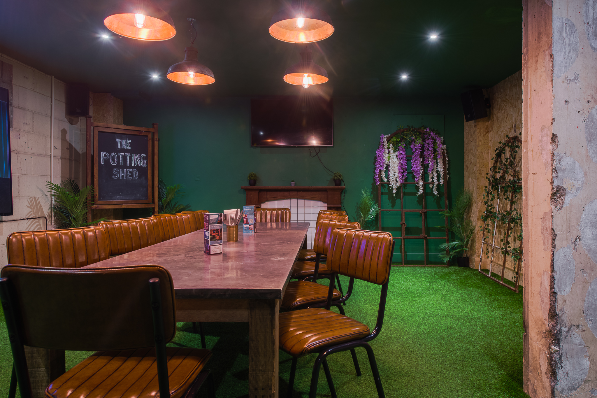 Cozy meeting space with wooden table for workshops in The Potting Shed, Swansea.