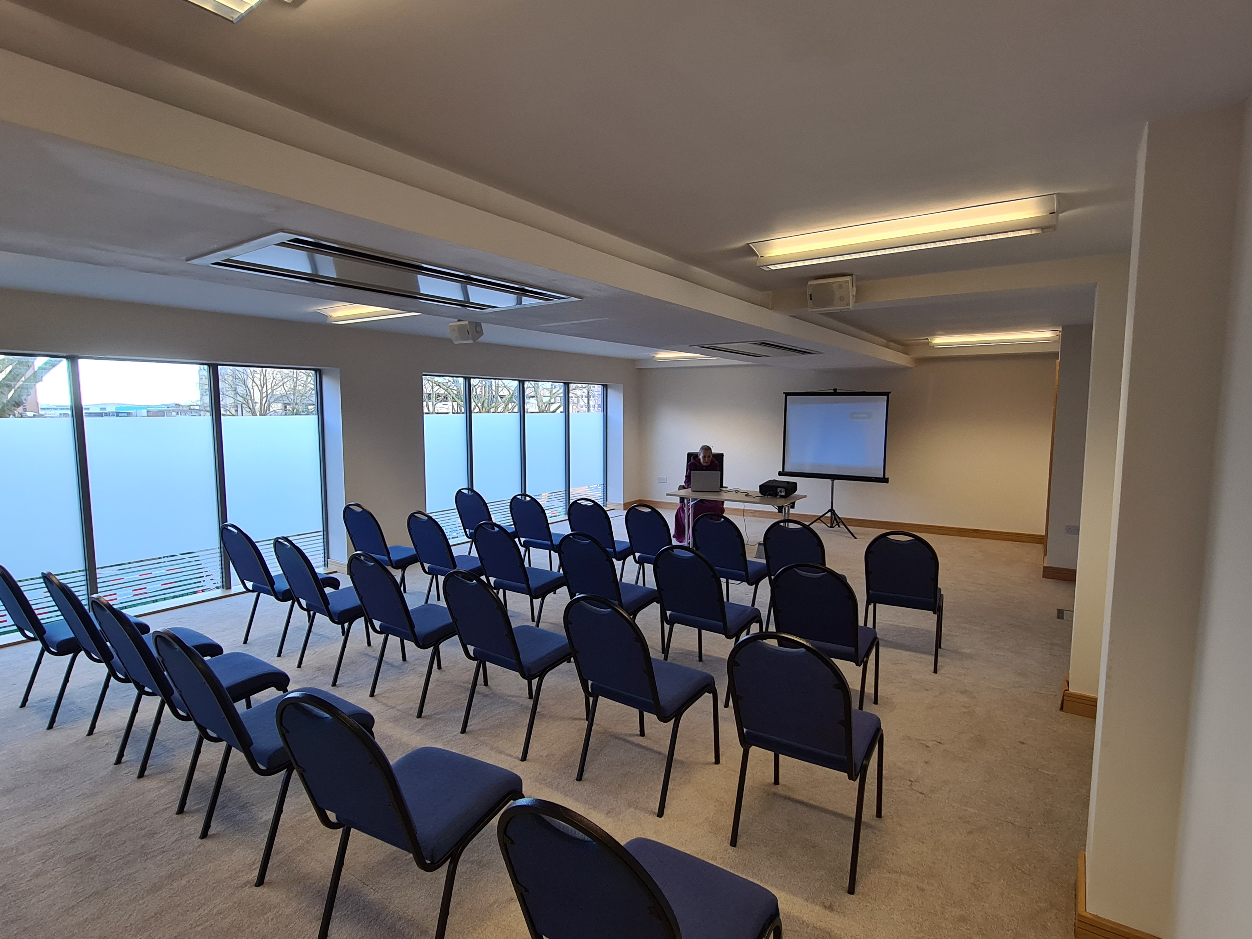 Upper Floor Suite meeting room with blue chairs, perfect for workshops and seminars.