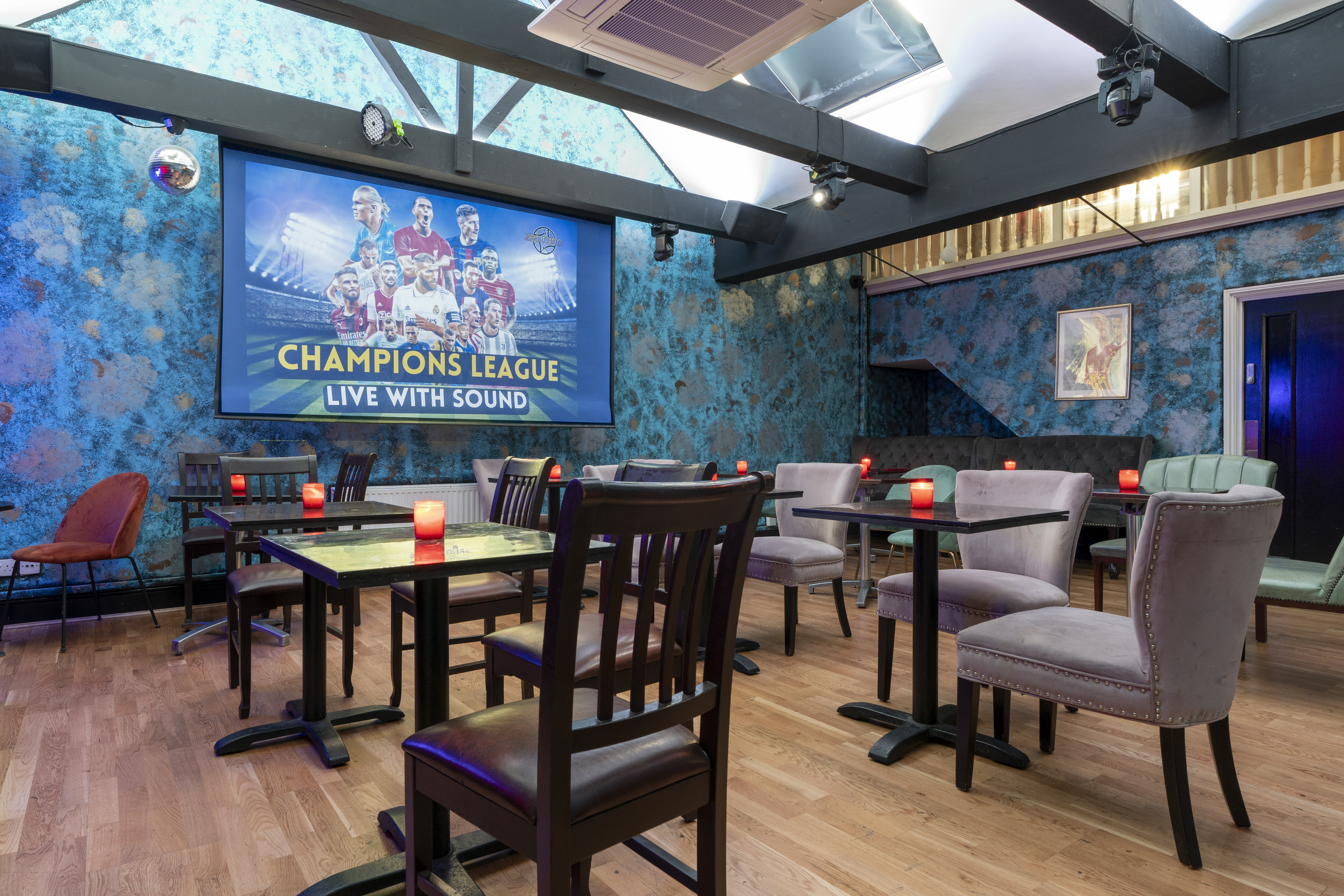 Intimate event space in Zebrano Soho with vibrant blue decor, ideal for gatherings.