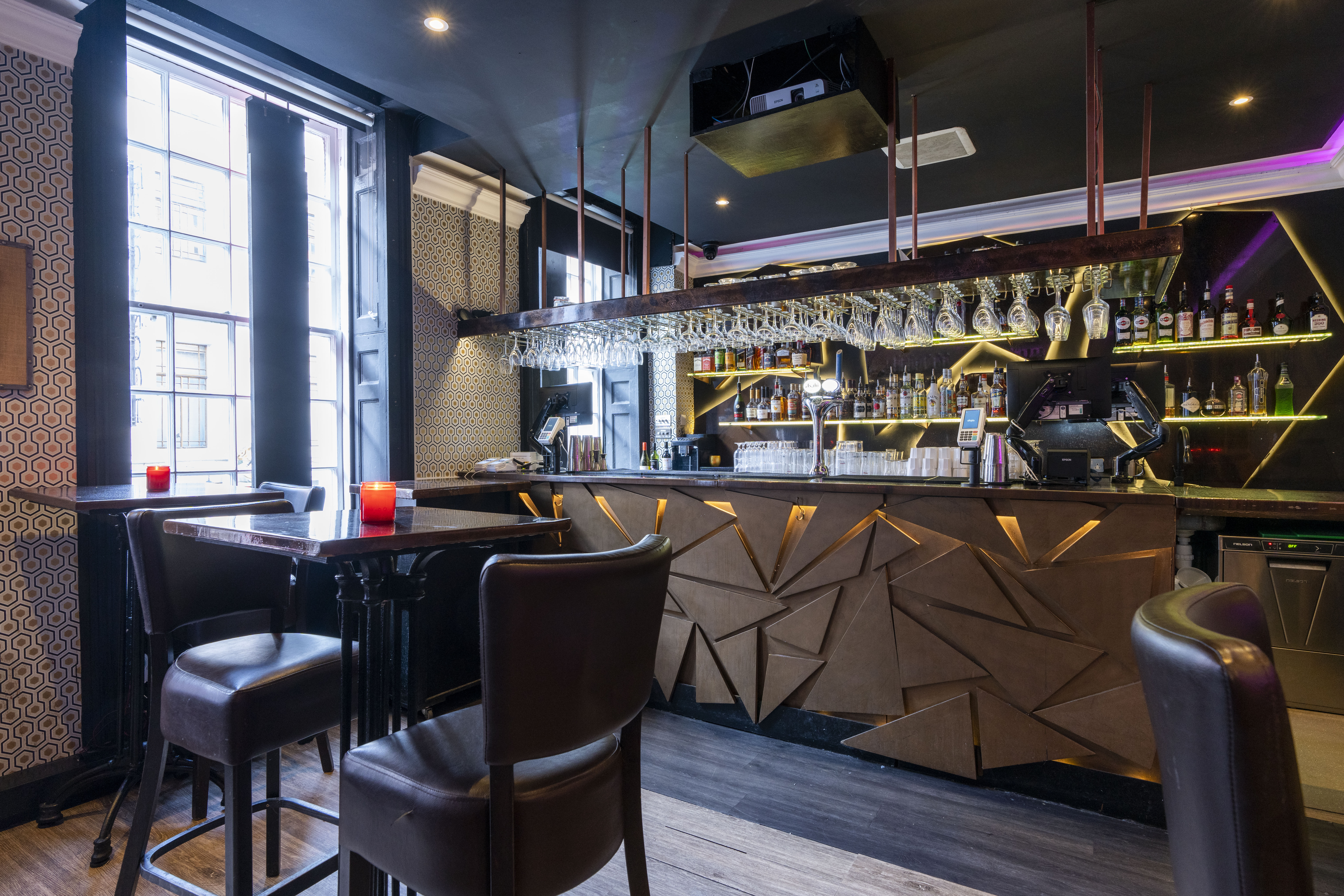 Modern bar at Zebrano Soho, featuring geometric decor for networking events.