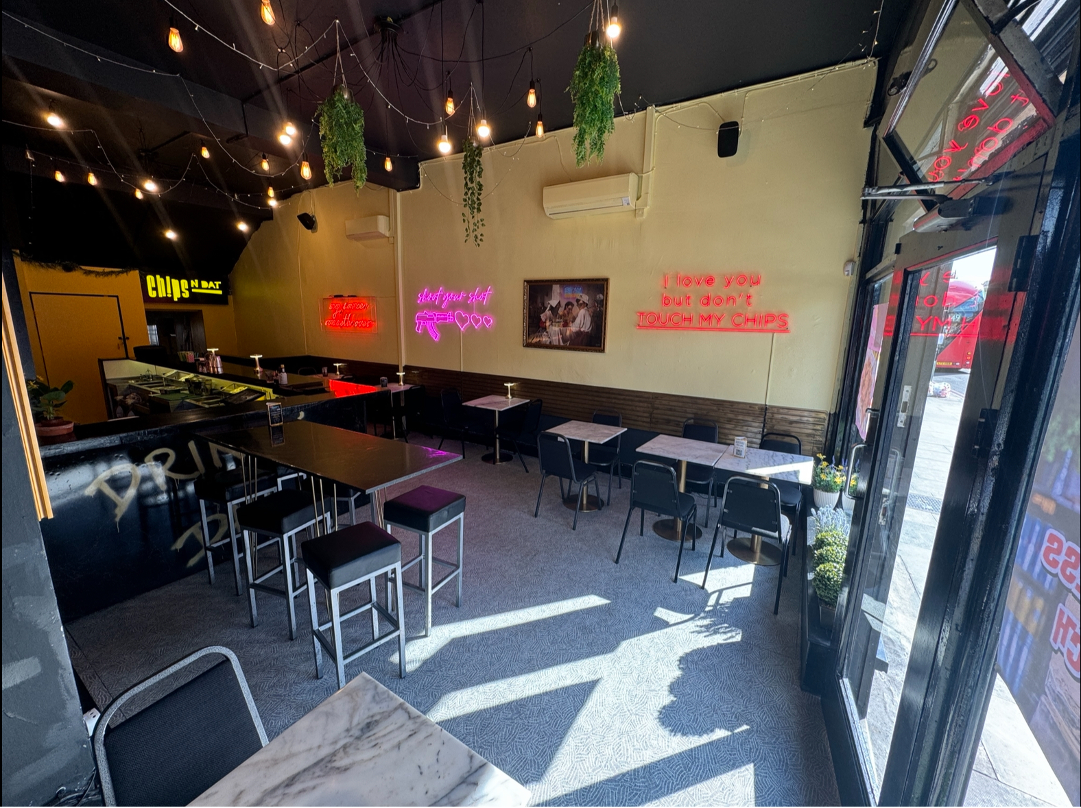 Modern venue with neon signage, perfect for networking events and casual gatherings.