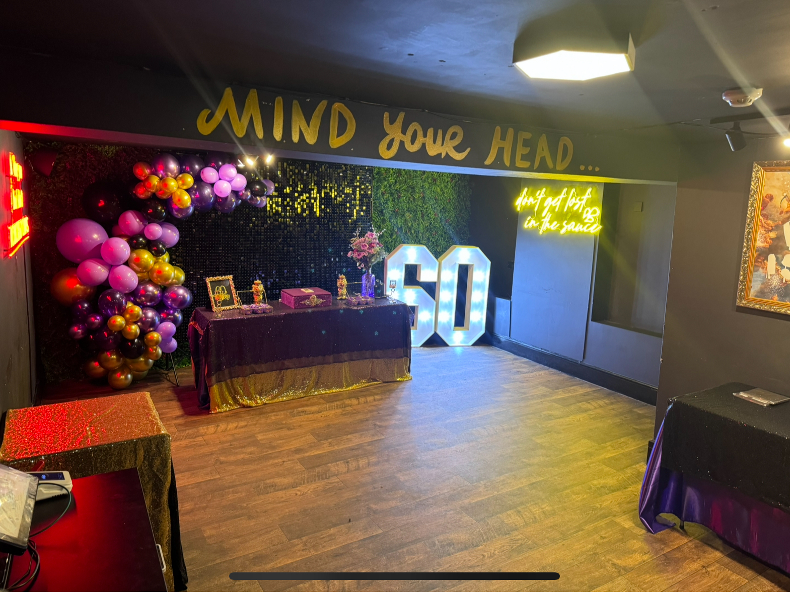 Vibrant birthday celebration with colorful balloons and elegant decor in event space.