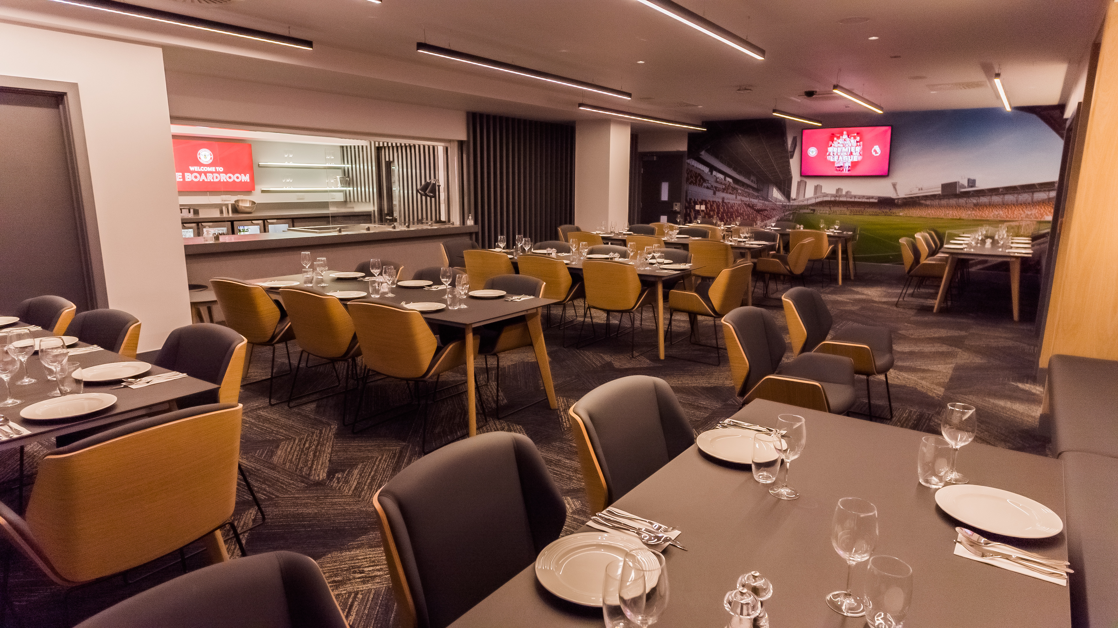 Modern dining setup in The Boardroom, Brentford FC for corporate events and celebrations.