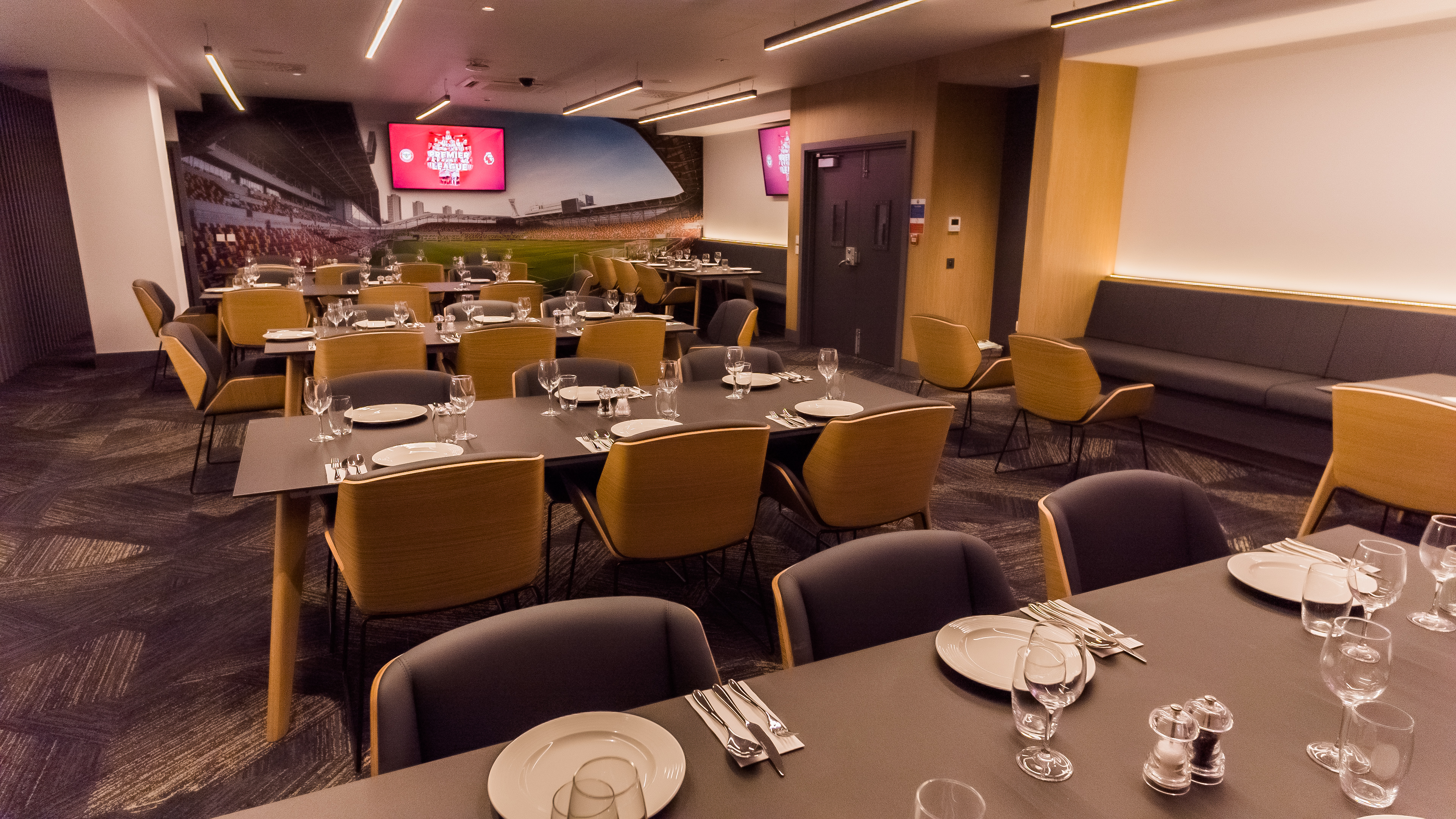 Modern dining setup in The Boardroom at Brentford FC for corporate events.