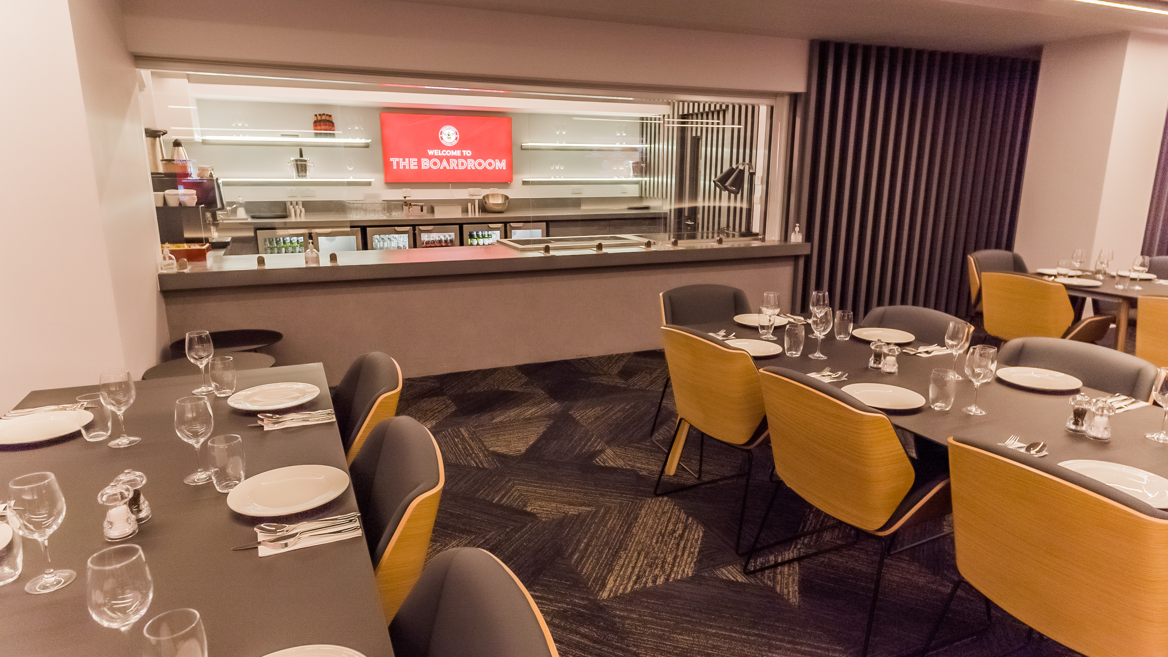 Modern dining space at Brentford FC with sleek tables for corporate events.