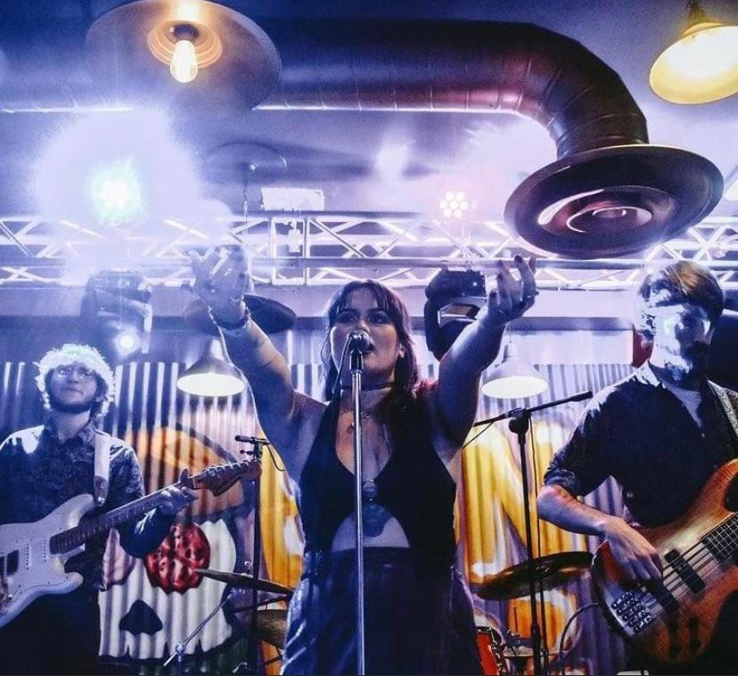 Misfits live performance with vibrant lighting at a corporate event or celebration.