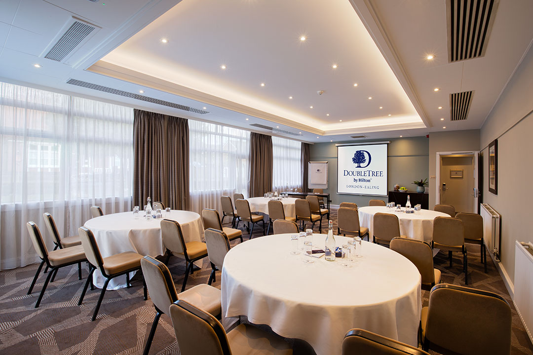 Springfield Suite meeting room with round tables, ideal for corporate events and presentations.