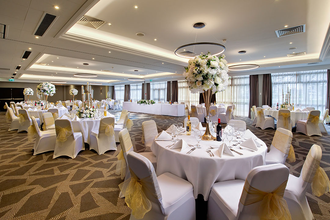 Springfield Suite at DoubleTree Ealing, elegant wedding event space with floral centerpieces.
