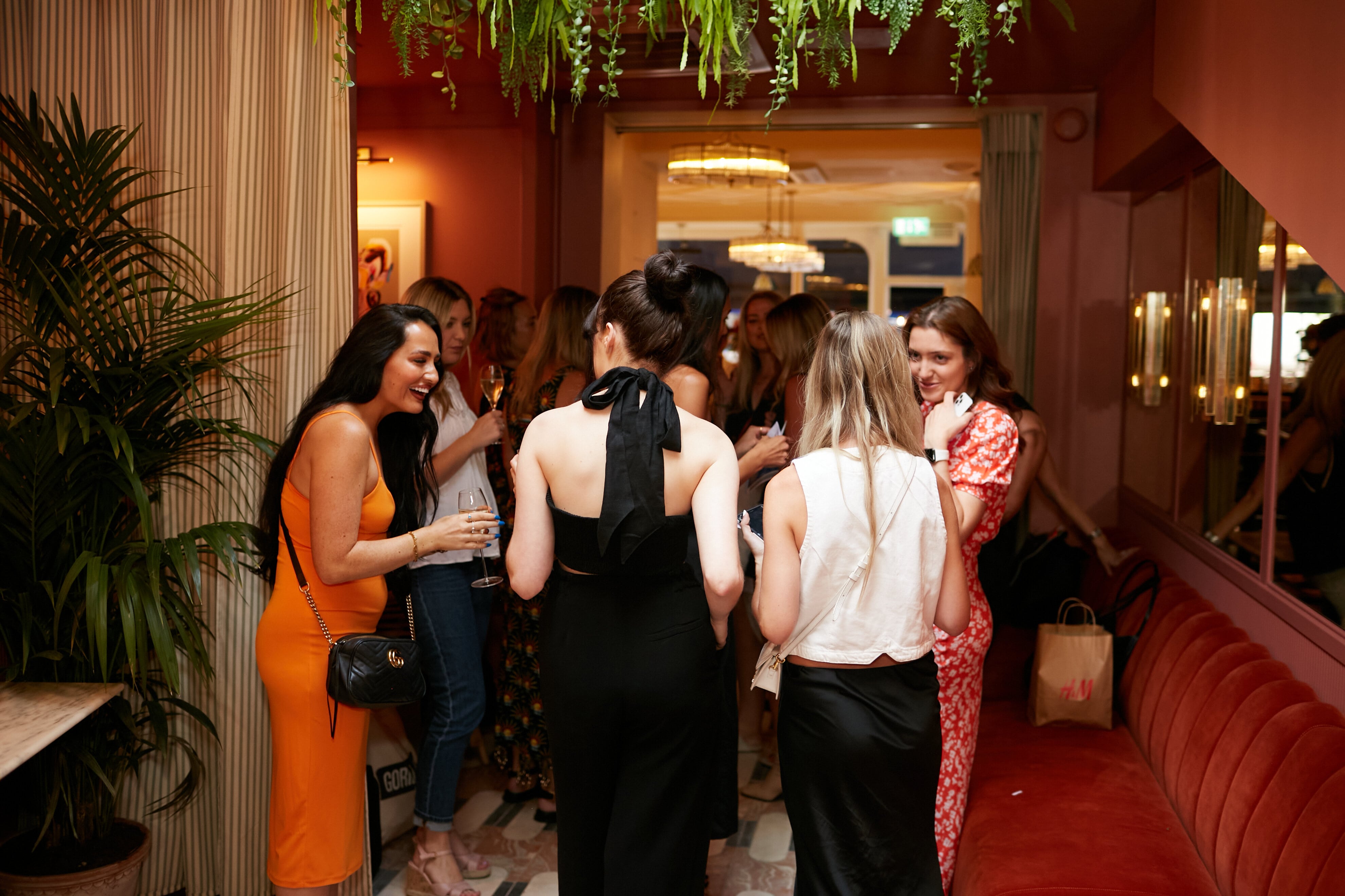 Vibrant networking event at Mina's venue with outdoor terrace and lush greenery.