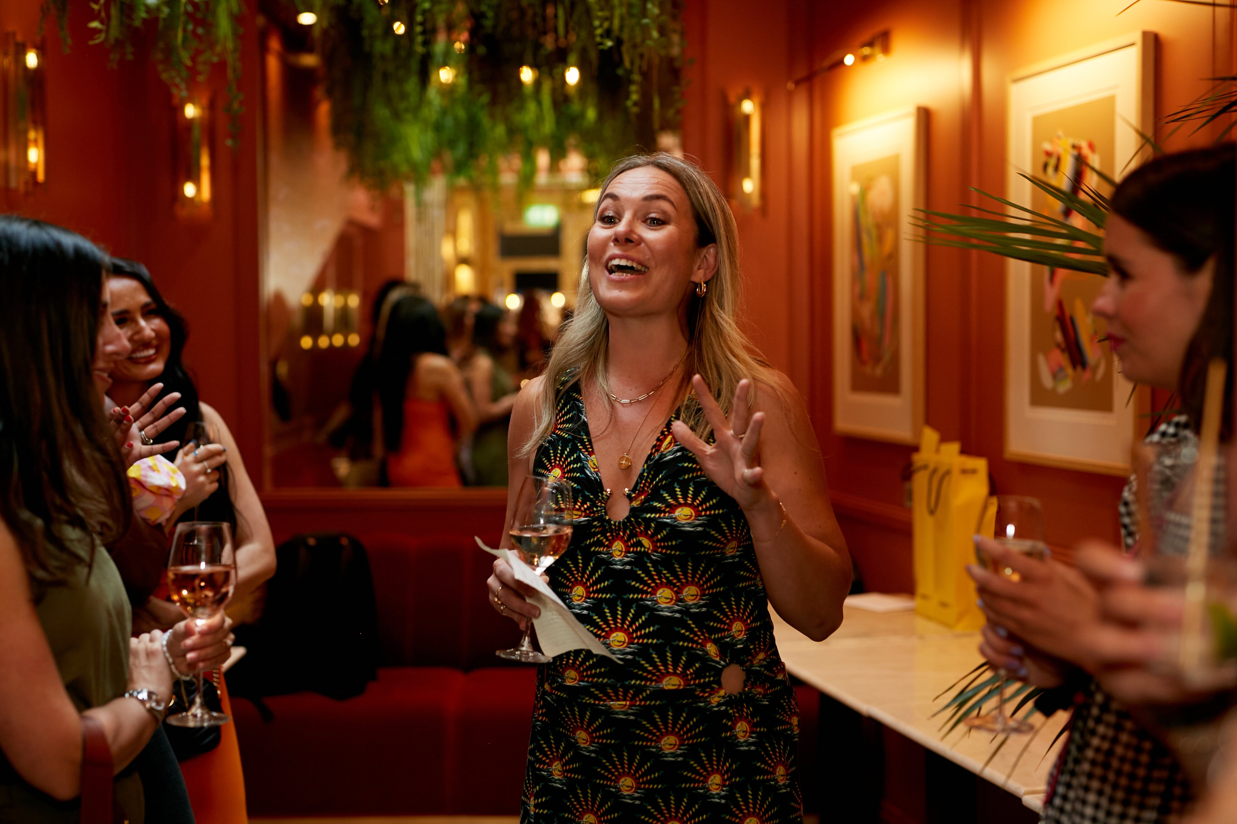 Vibrant networking event at Mina's venue with outdoor terrace and engaging speaker.