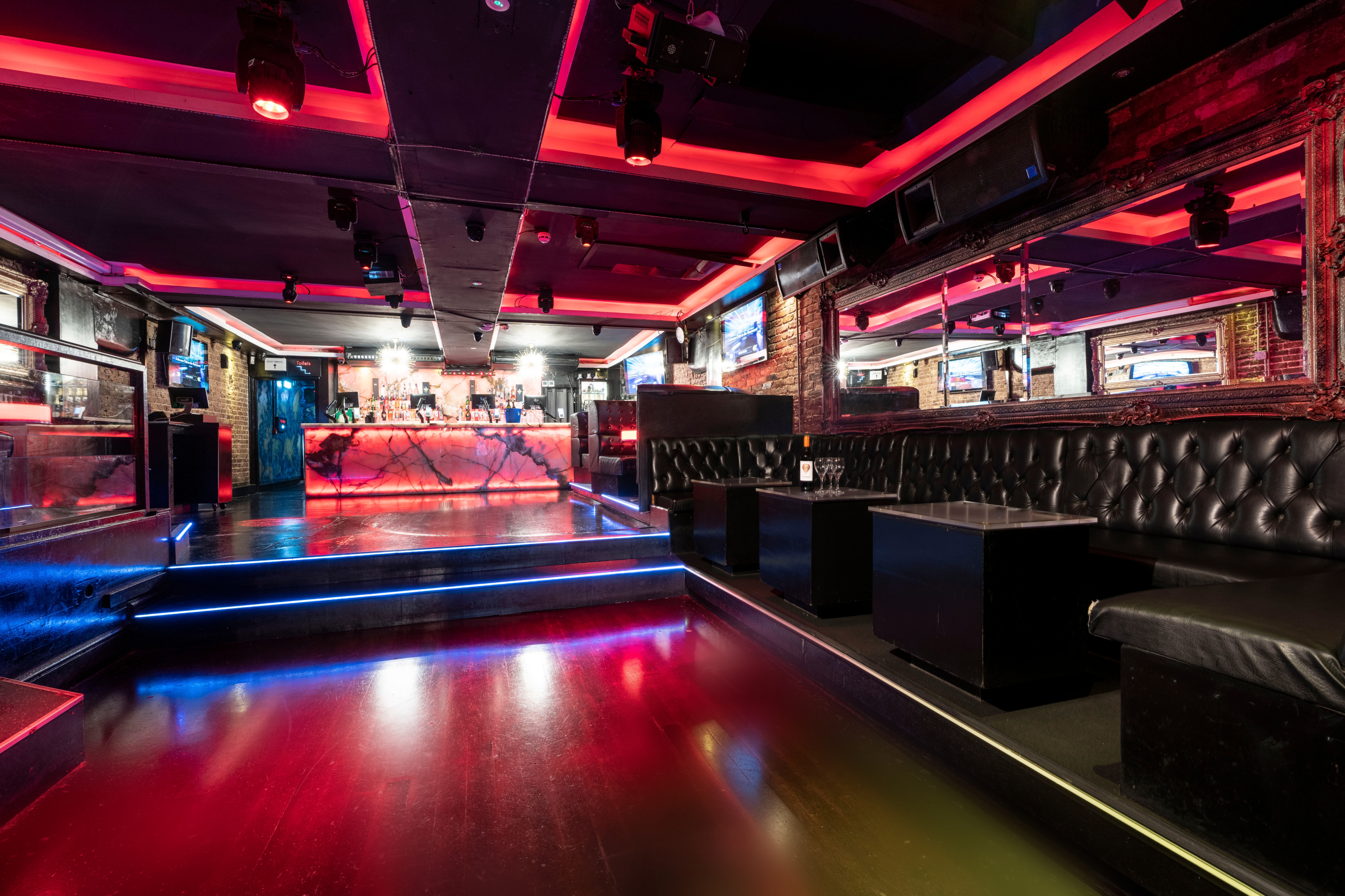 Modern Zebrano Soho event space with illuminated bar, ideal for networking and private parties.