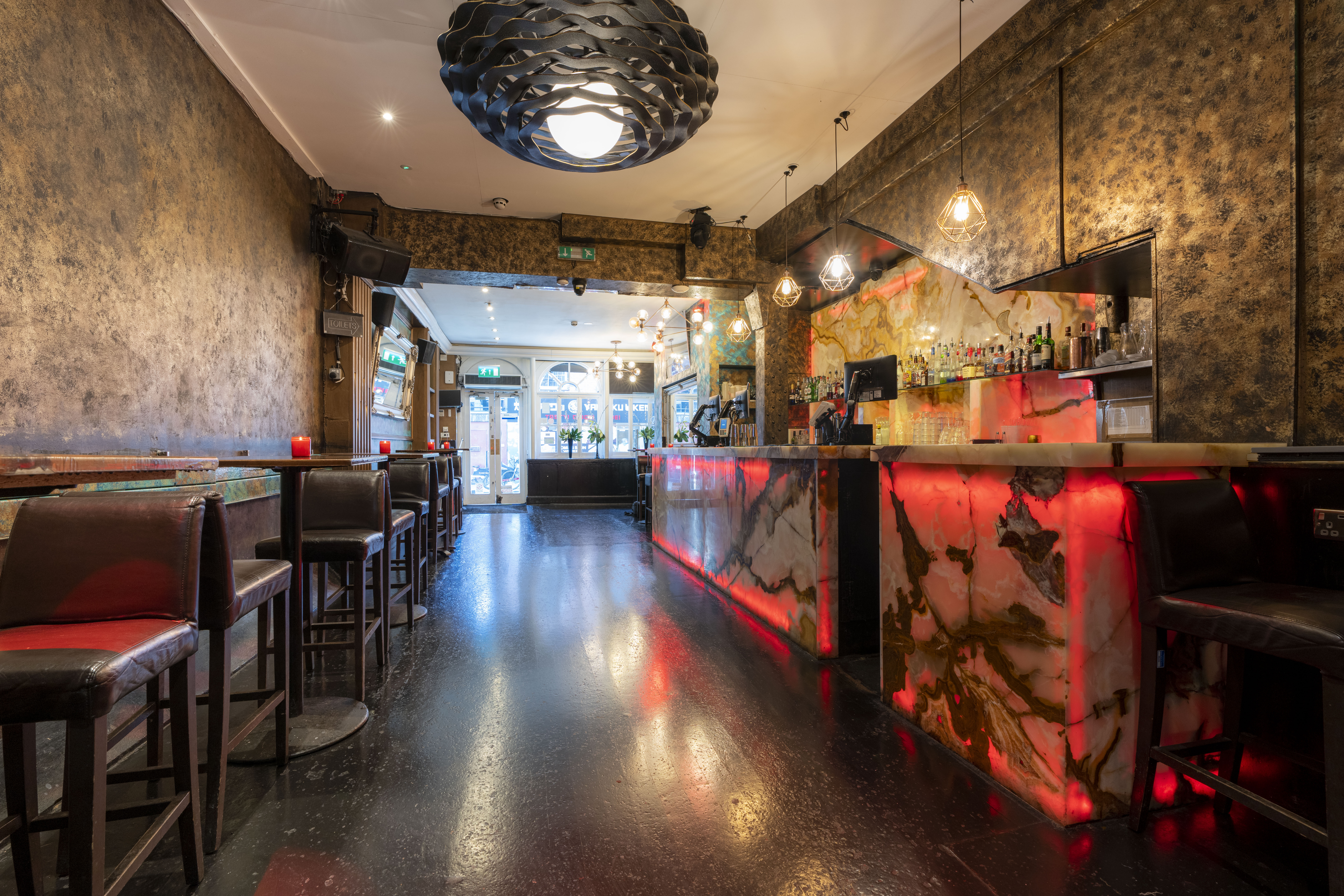 Stylish bar venue with marble countertop, perfect for networking events in Zebrano Soho.
