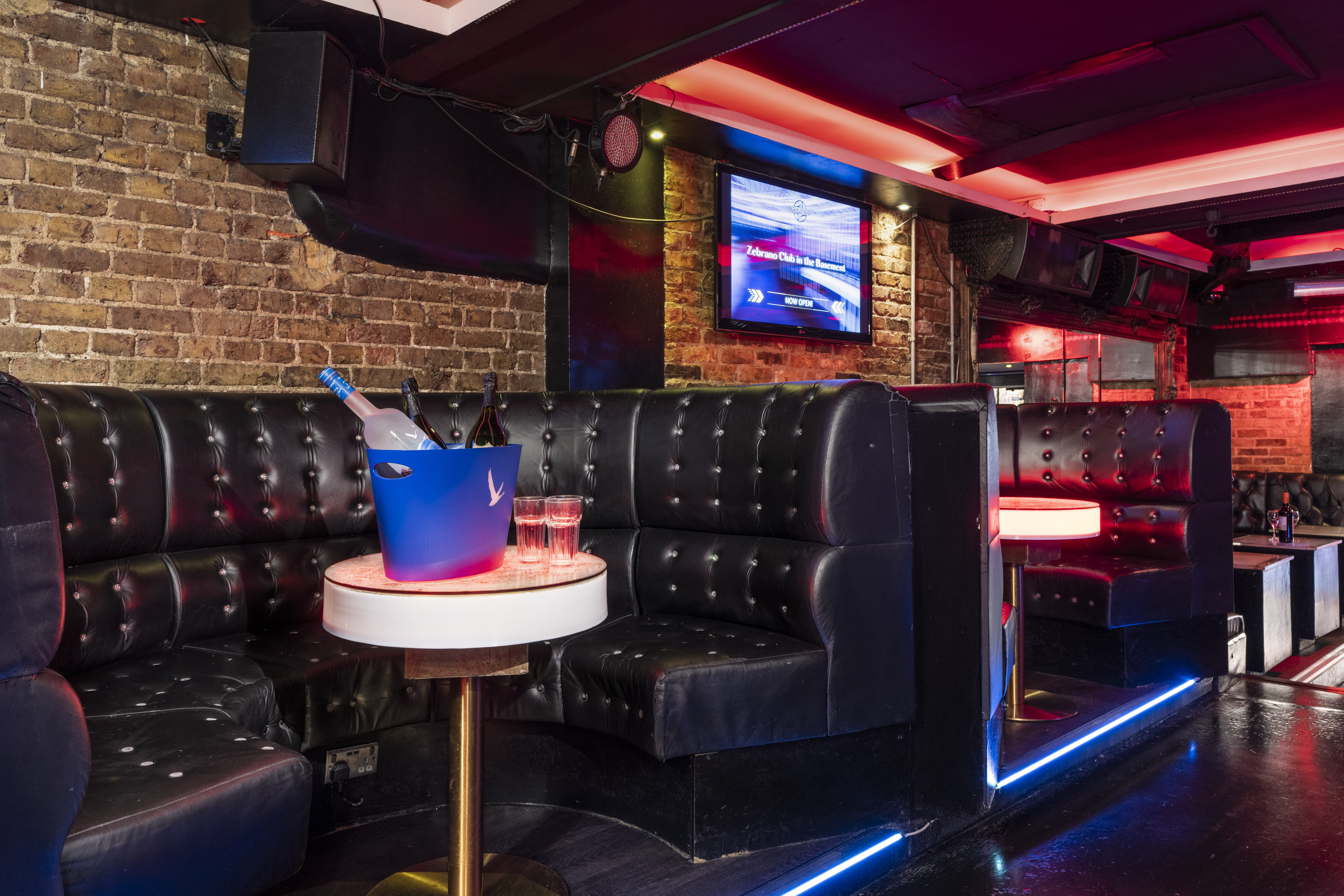 Stylish event space in Zebrano Soho with black seating, ideal for parties and networking.