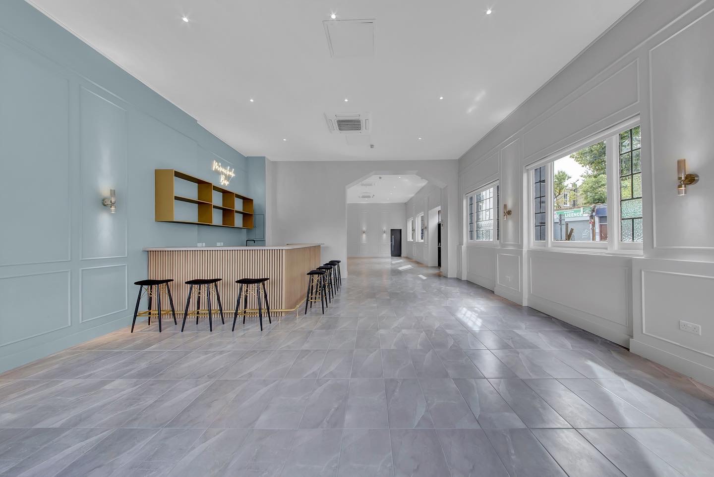 Elegant event space in Mnuchah with light blue accents, perfect for receptions and networking.