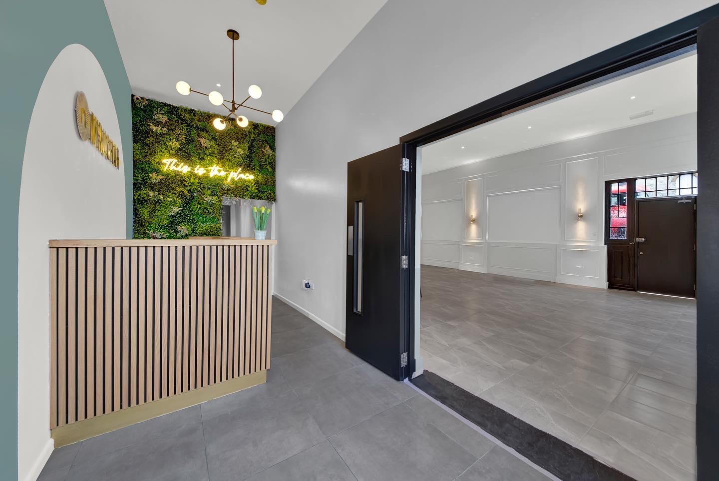 Modern event space in Mnuchah with stylish lighting and natural light for gatherings.