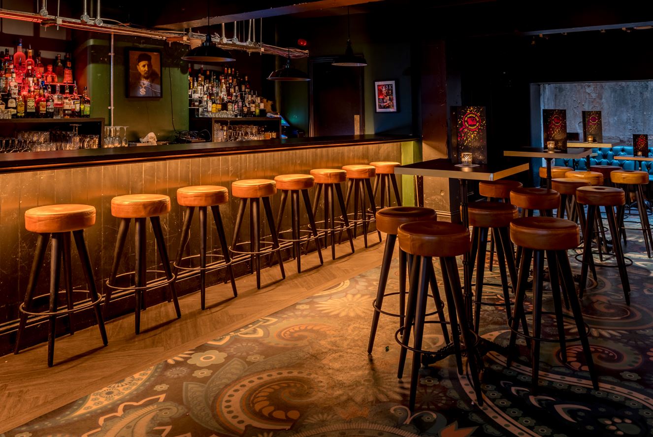 Stylish bar with wooden stools in The Cocktail Club Bristol, ideal for networking events.