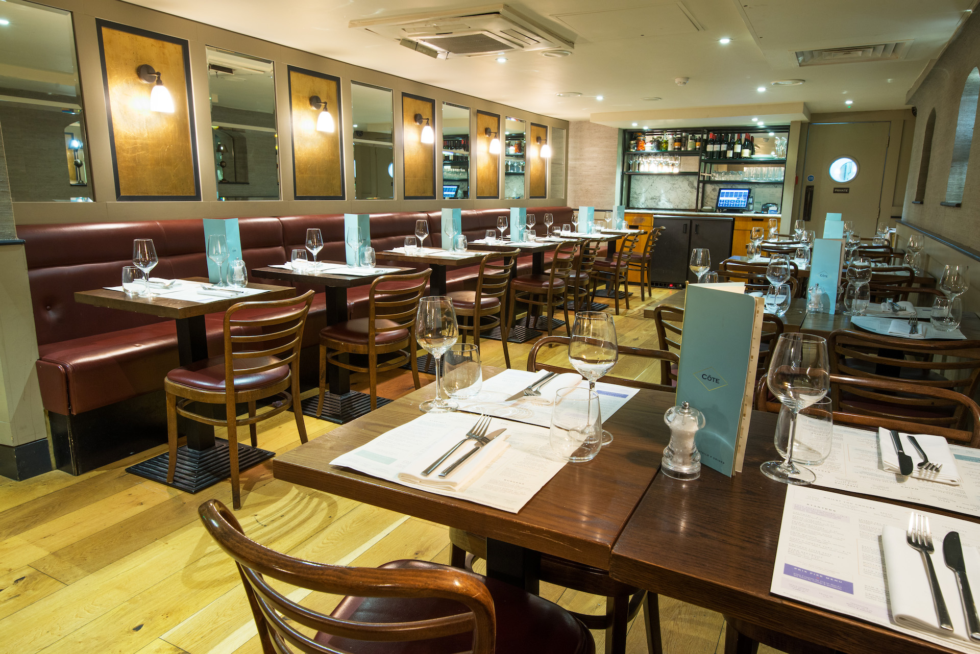 Private dining room at Cote Brasserie, elegant tables for intimate gatherings and events.