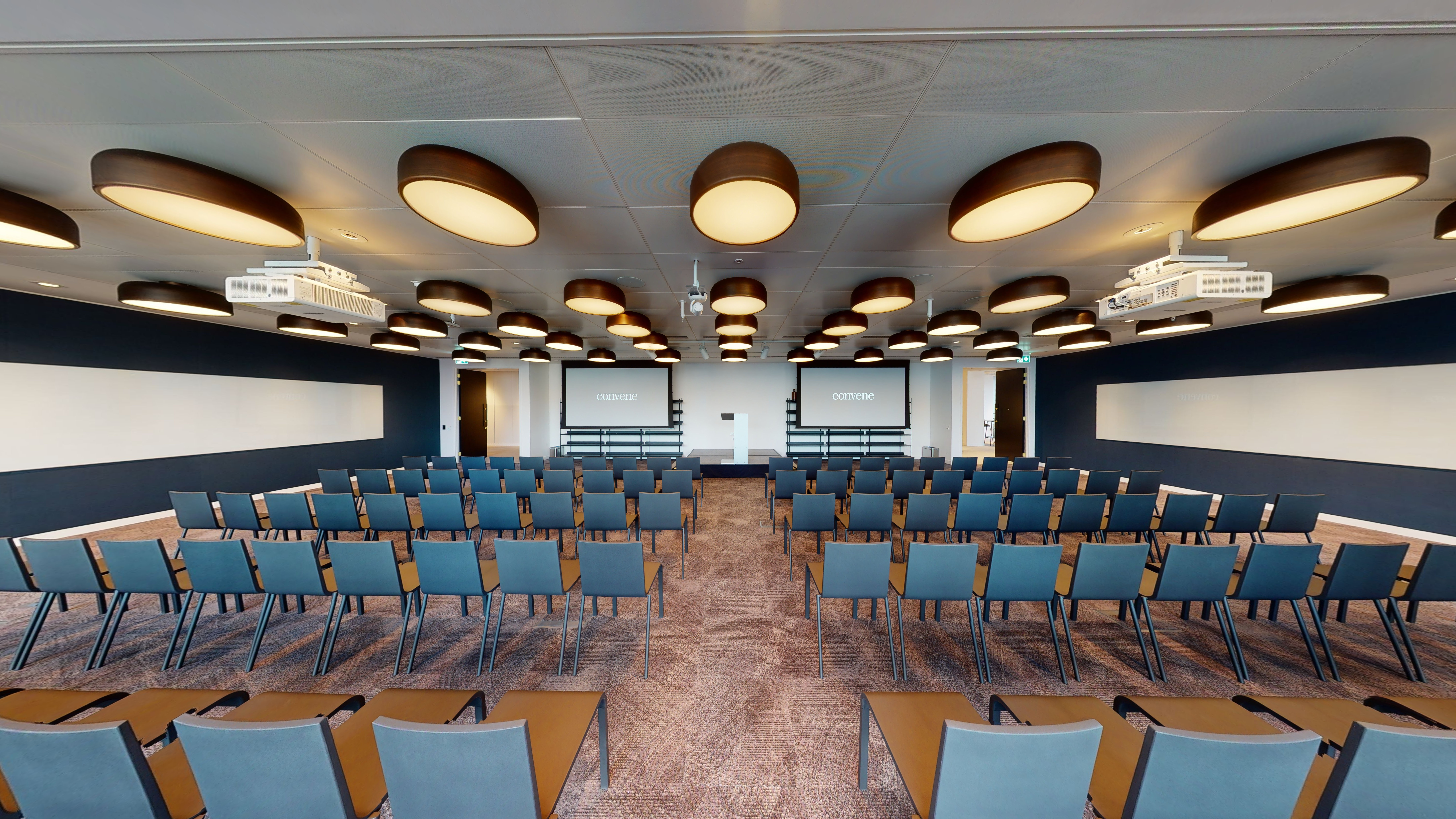 Conference room at Gracechurch Hub with modern chairs and dual screens for events.