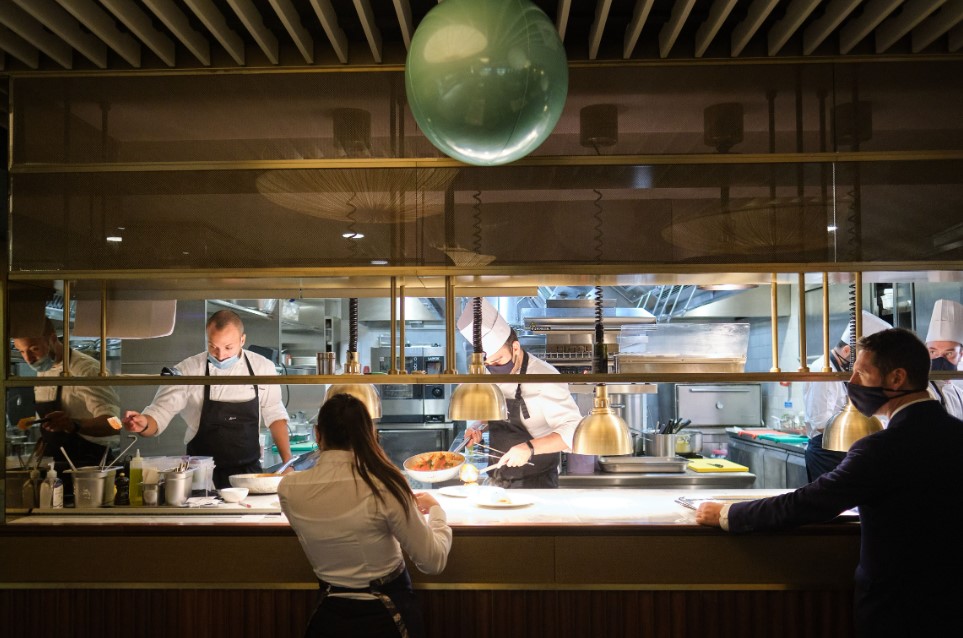 "IT London Space kitchen, chefs collaborating for upscale culinary events and dining experiences."