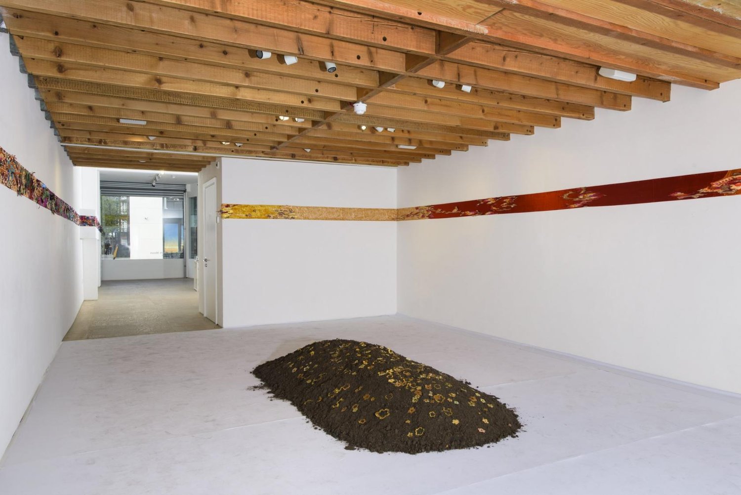 Minimalist gallery space with earthy installation, perfect for art exhibitions and creative events.