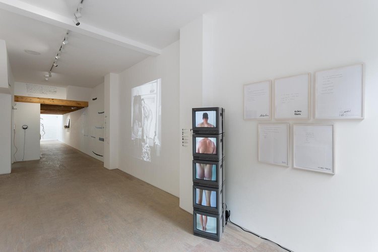 Minimalist gallery space with projection, ideal for art exhibitions and events.