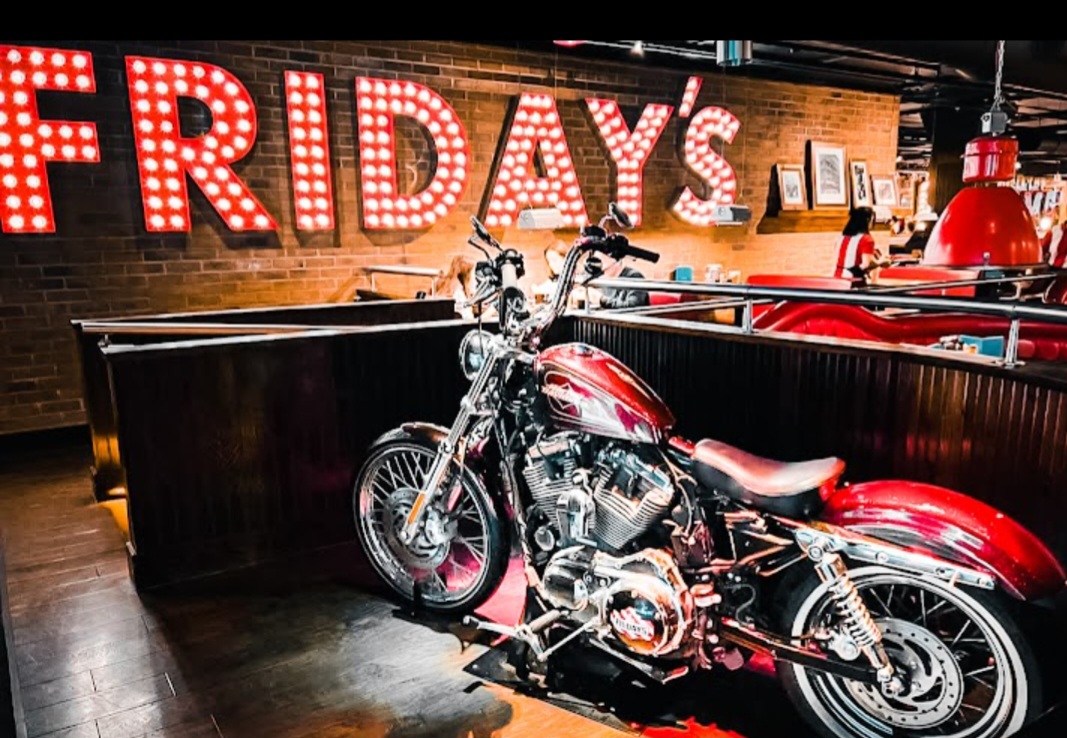 Vibrant restaurant venue with motorcycle display, ideal for casual gatherings and events.