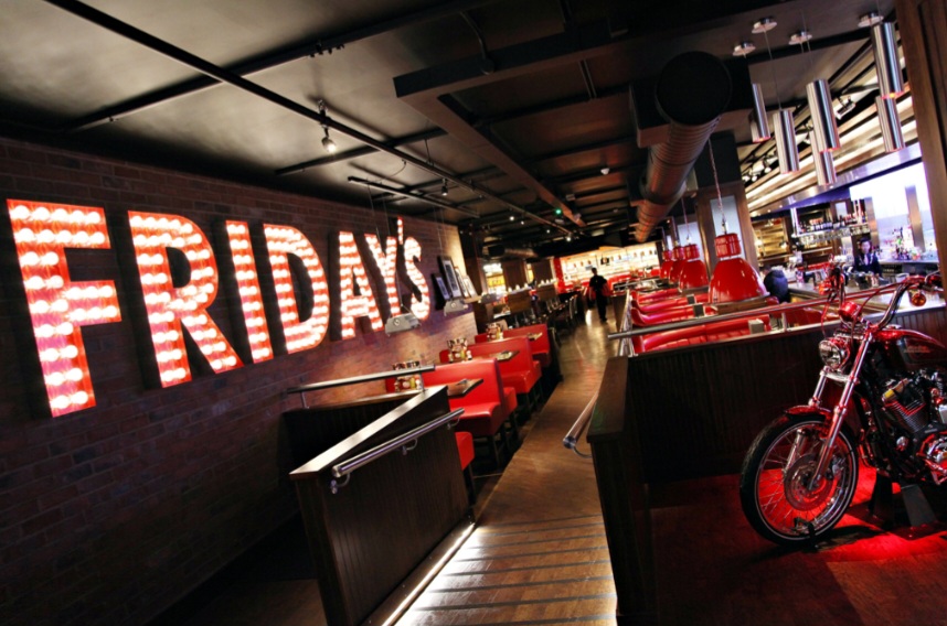 Vibrant Fridays Royal Exchange venue with red seating, ideal for casual gatherings and events.