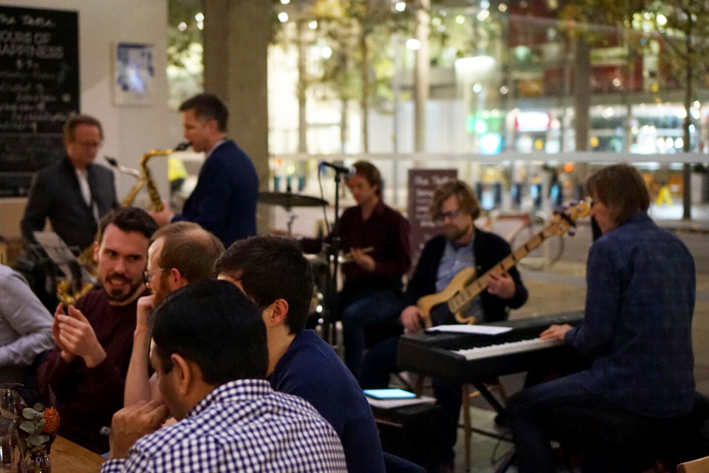 Live music event at The Table Cafe with warm lighting and relaxed seating.