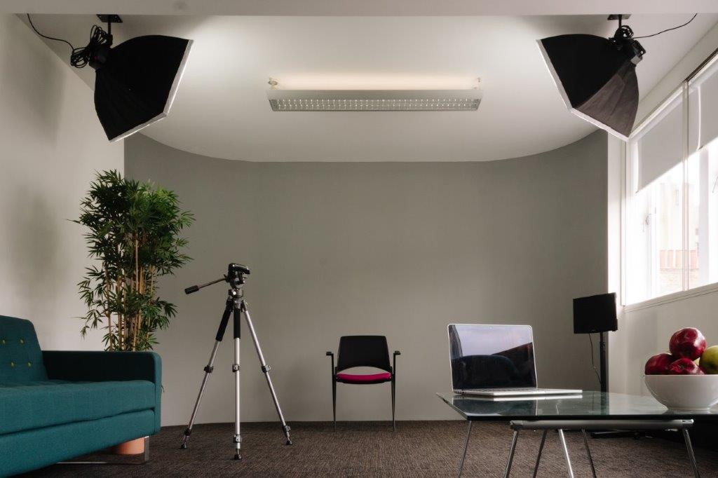 Minimalist video conferencing space with professional lighting for meetings and events.
