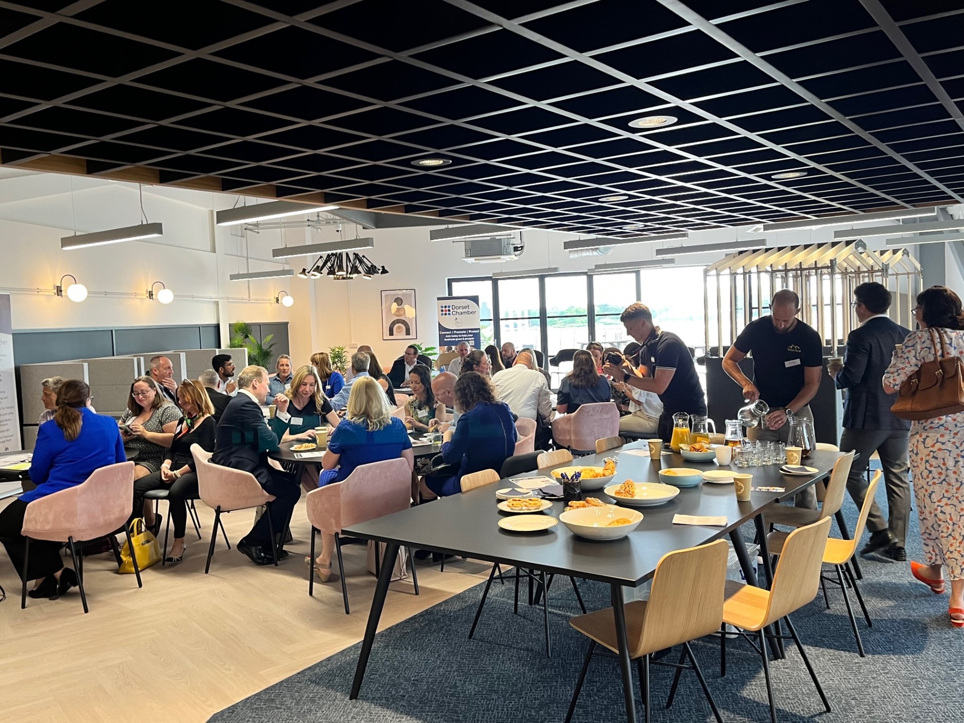 Vibrant networking event at SmartBase with attendees engaged in conversation.