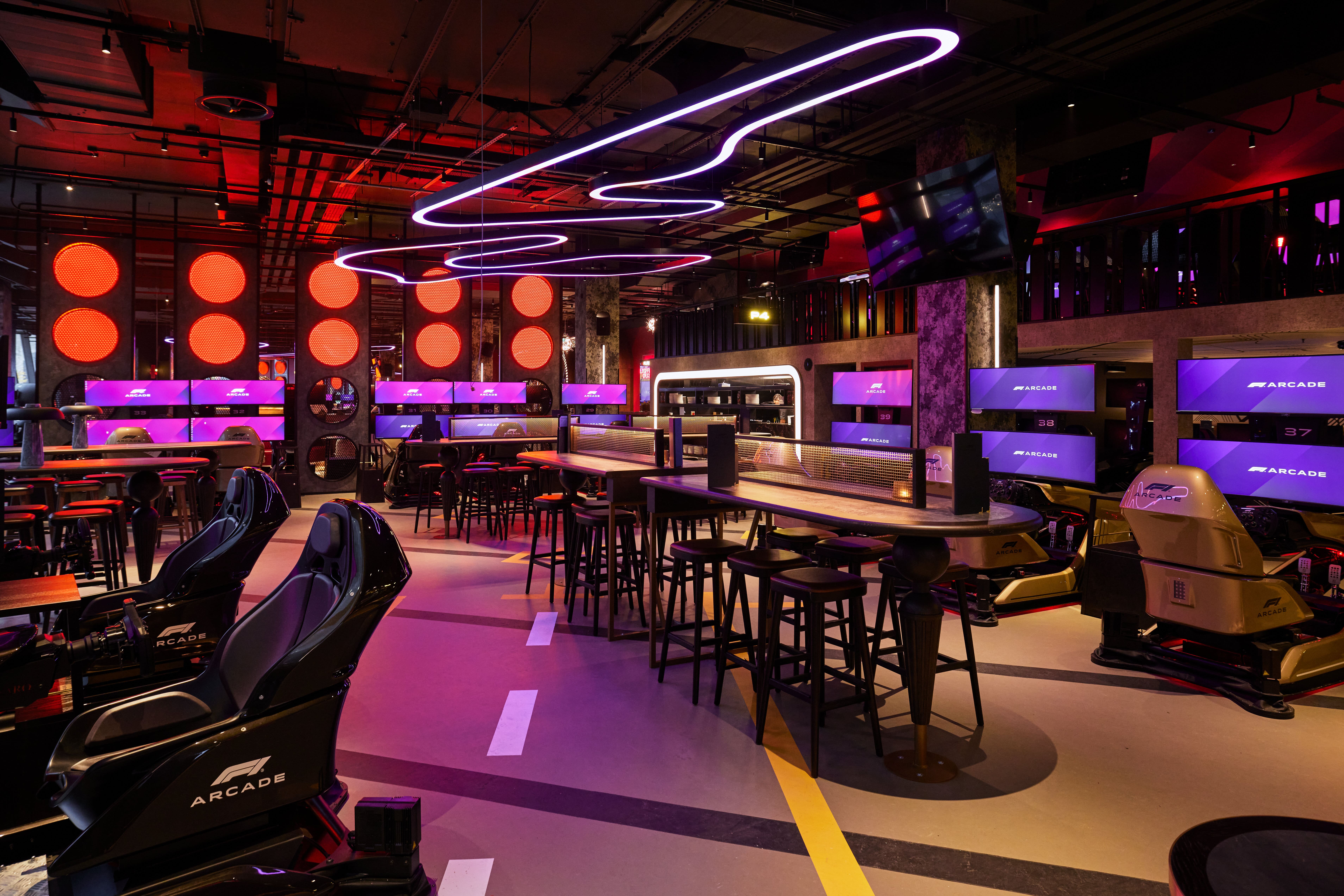 F1 Arcade venue with sleek seating, ideal for networking and entertainment events.