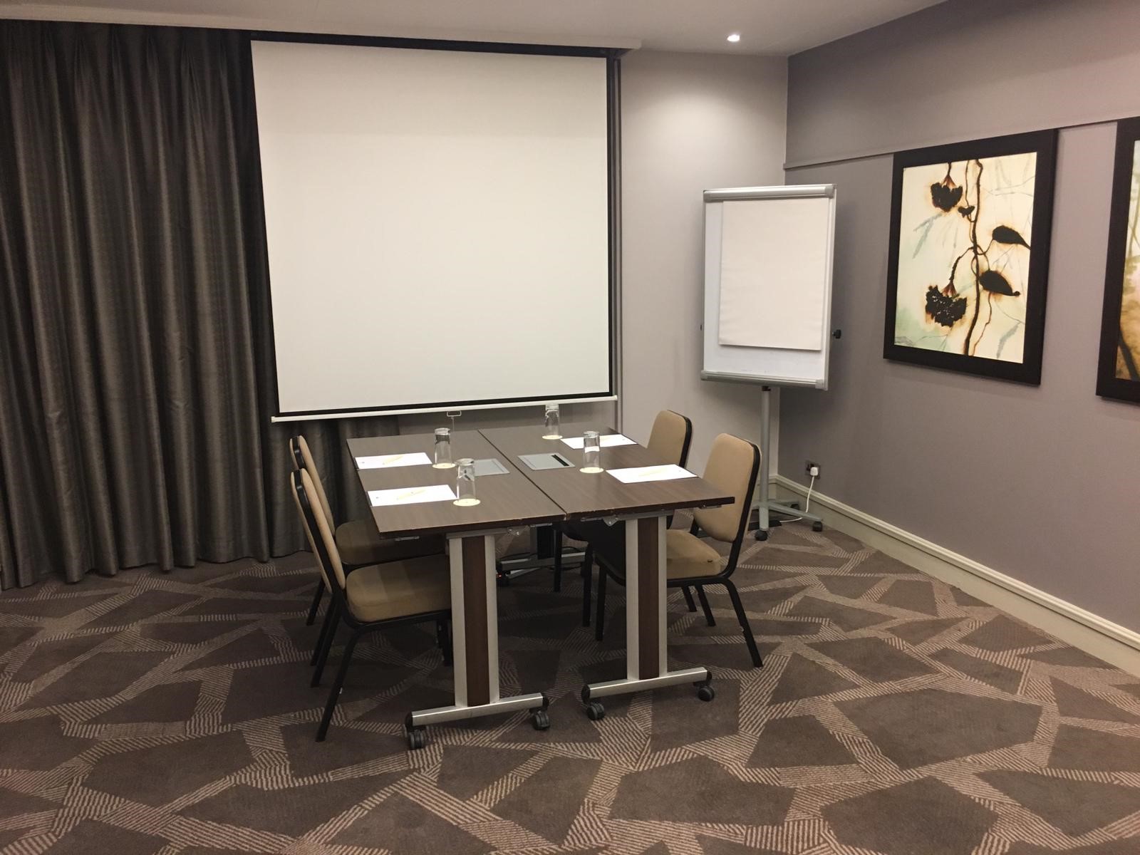 Townshend Suite meeting room with projector, ideal for presentations and discussions.