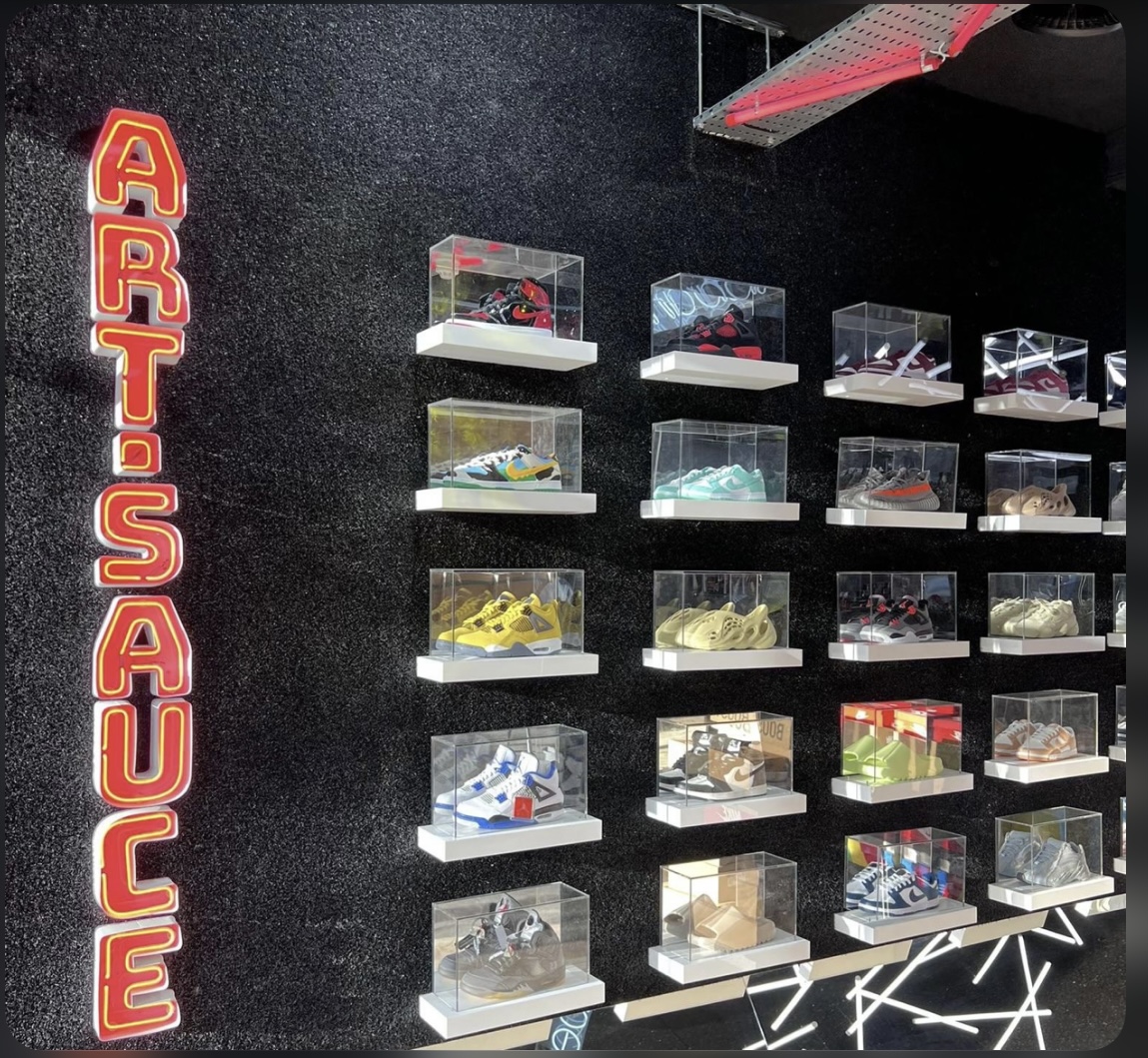 Stylish sneaker display in clear cases for a trendy product launch event.