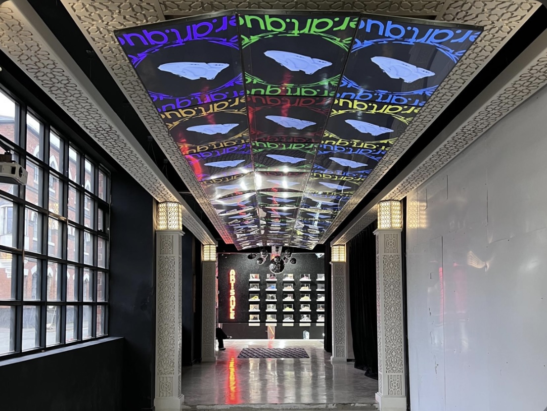 Modern event space with vibrant ceiling projections for corporate events and creative gatherings.