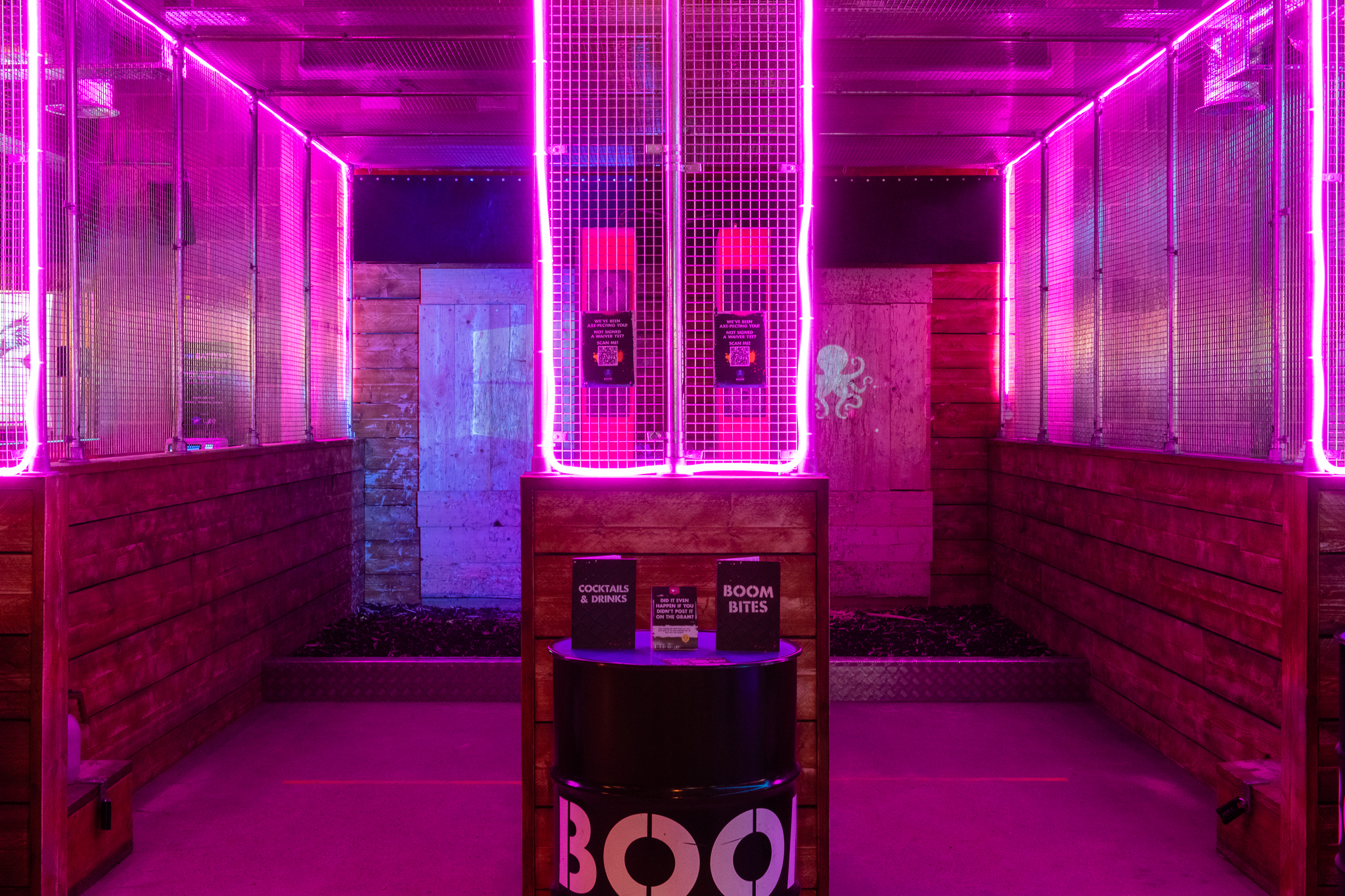 Vibrant private hire event space with neon pink lighting for parties and networking.