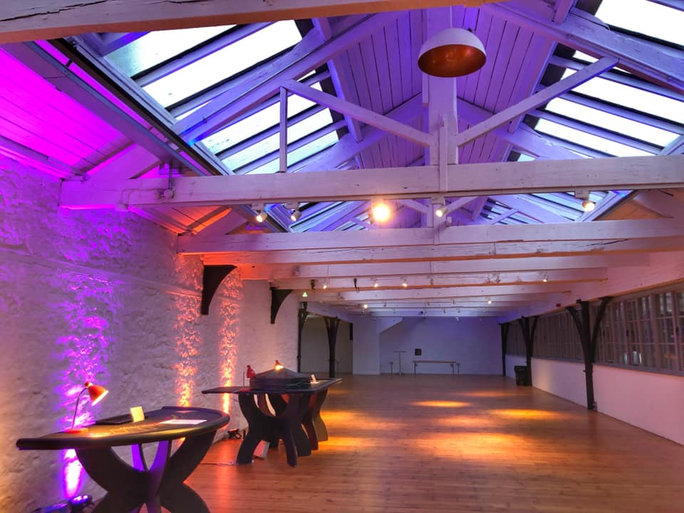 Modern event space with skylights, ideal for corporate meetings and social gatherings.