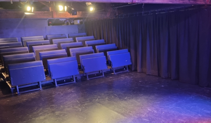 Versatile event space with tiered seating at Pleasance Theatre for workshops and performances.