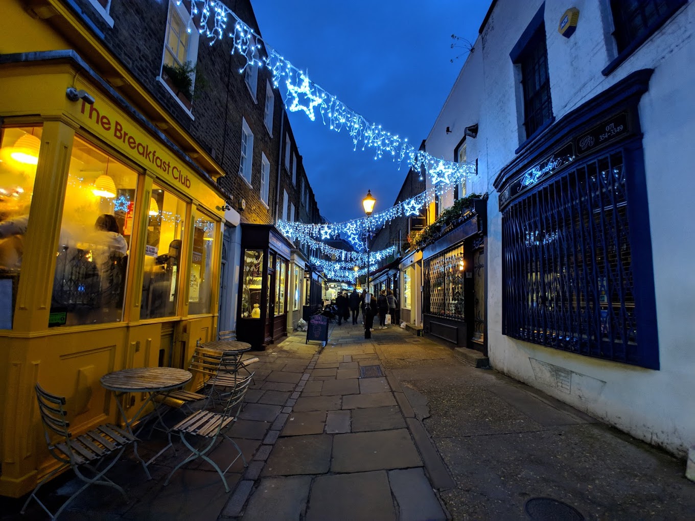 Charming illuminated alleyway at The Caf in The Breakfast Club, perfect for gatherings and events.