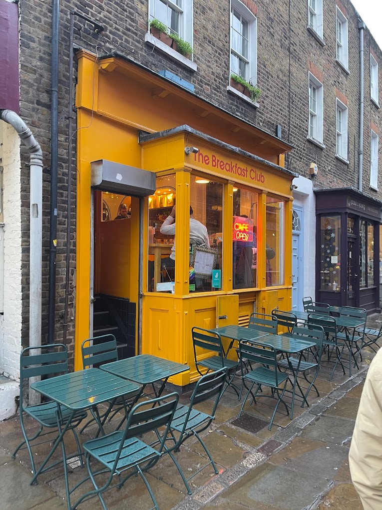 Vibrant yellow café exterior, ideal for casual networking events and brunch meetings.