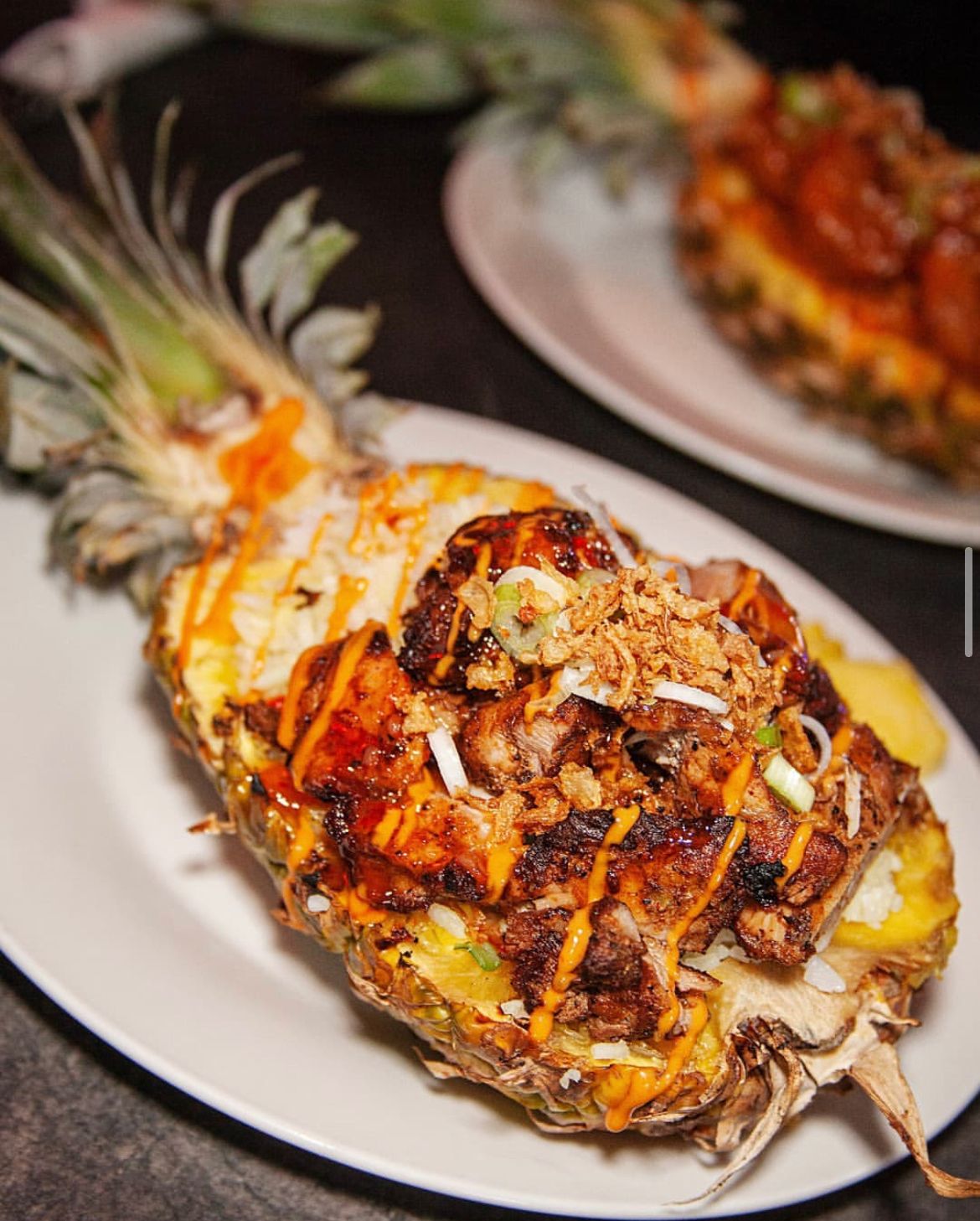 Vibrant grilled meat dish in a pineapple for tropical events and gatherings.