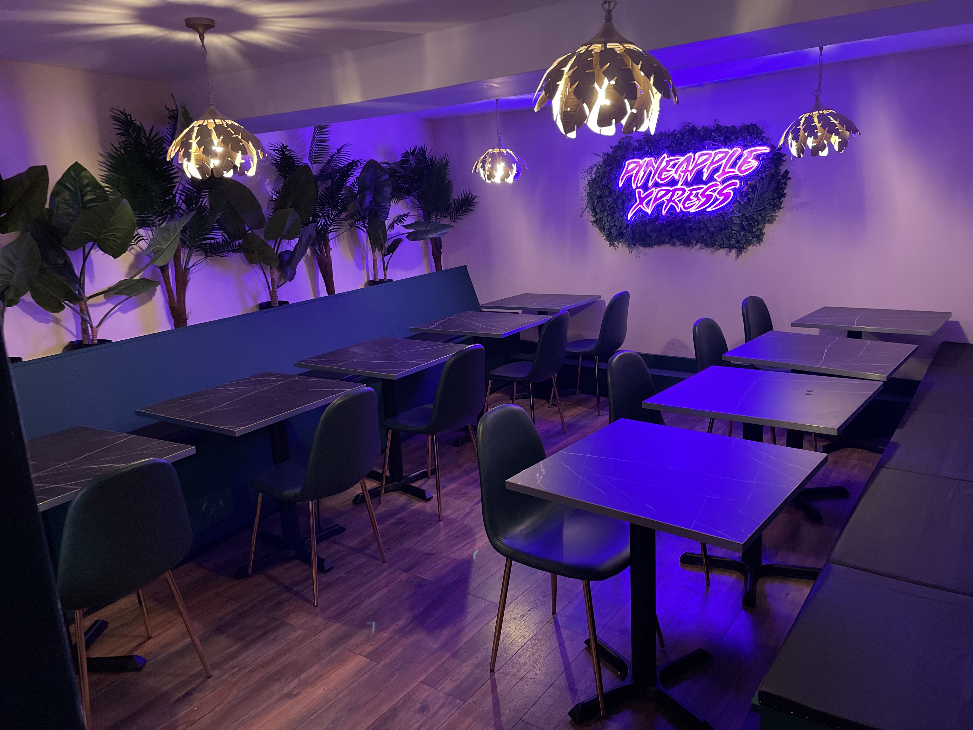 Stylish event space with neon sign, ideal for casual gatherings and networking.